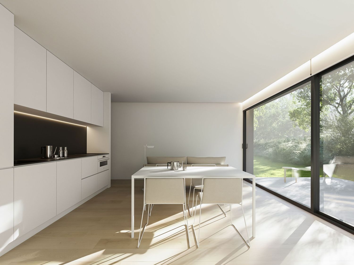 Modern minimalist white kitchen with sleek cabinetry and large windows offering natural light and outdoor views.