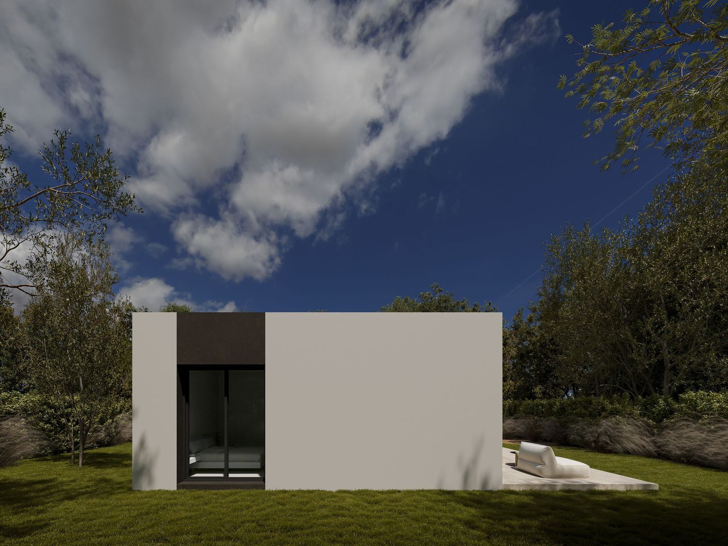 Modern minimalist white house with glass windows nestled among lush trees under blue cloudy sky.