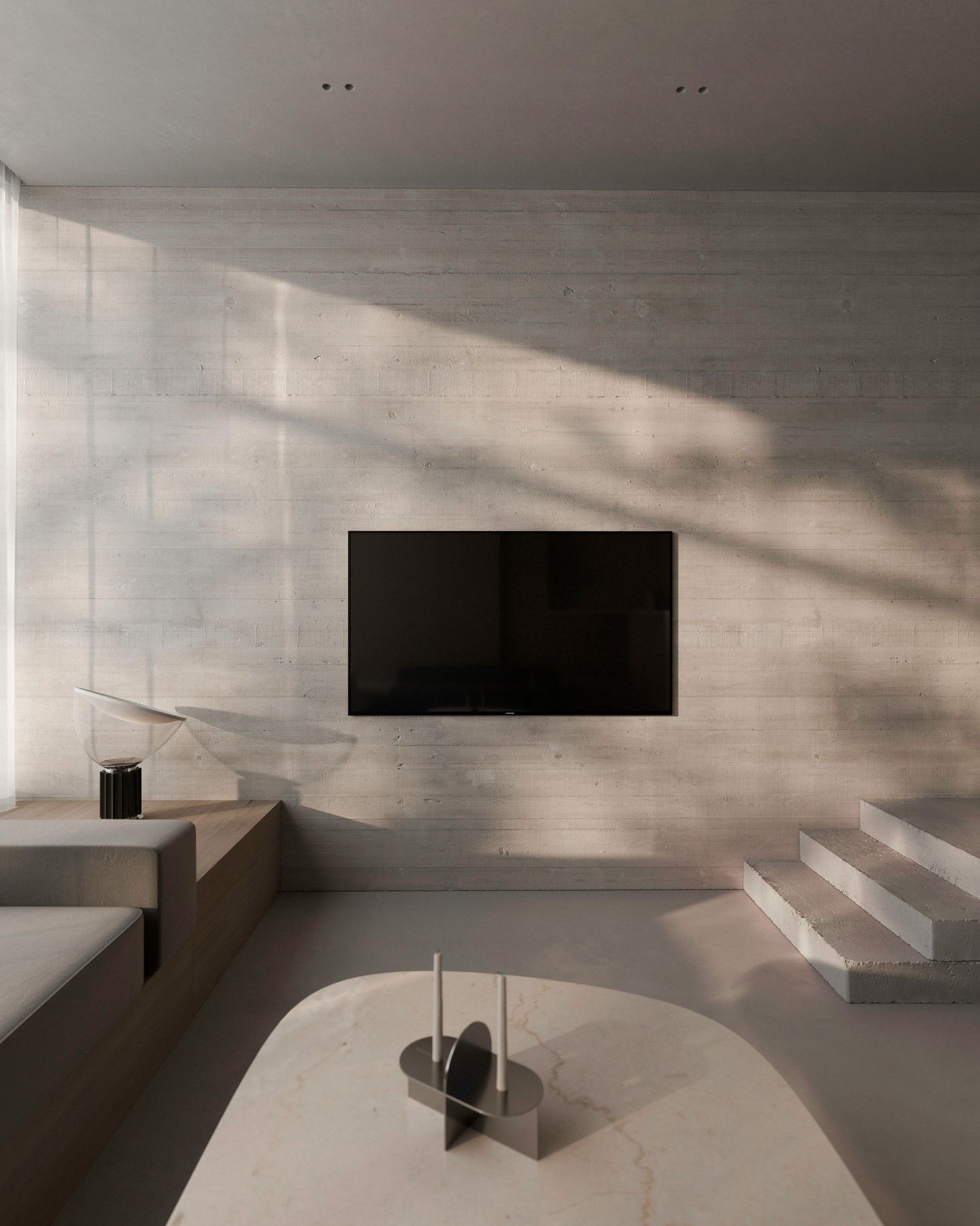 Modern minimalist living room with wall-mounted TV, white walls, sunlight casting shadows, and round coffee table.