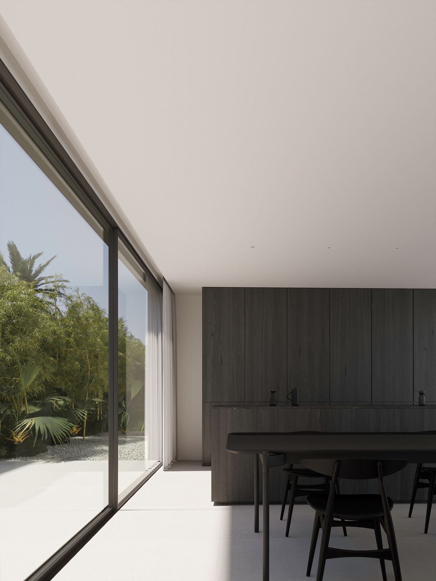 Modern minimalist dining room with floor-to-ceiling windows overlooking palm trees and sleek dark cabinets.