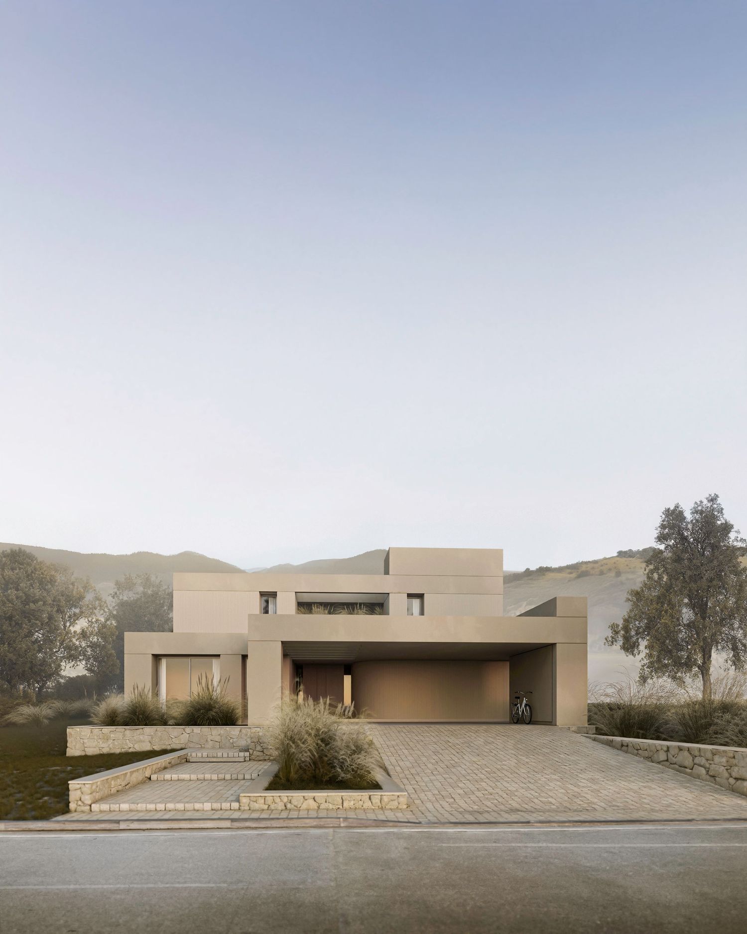 Modern beige stucco house with geometric architecture, paved driveway and desert landscaping at sunset.