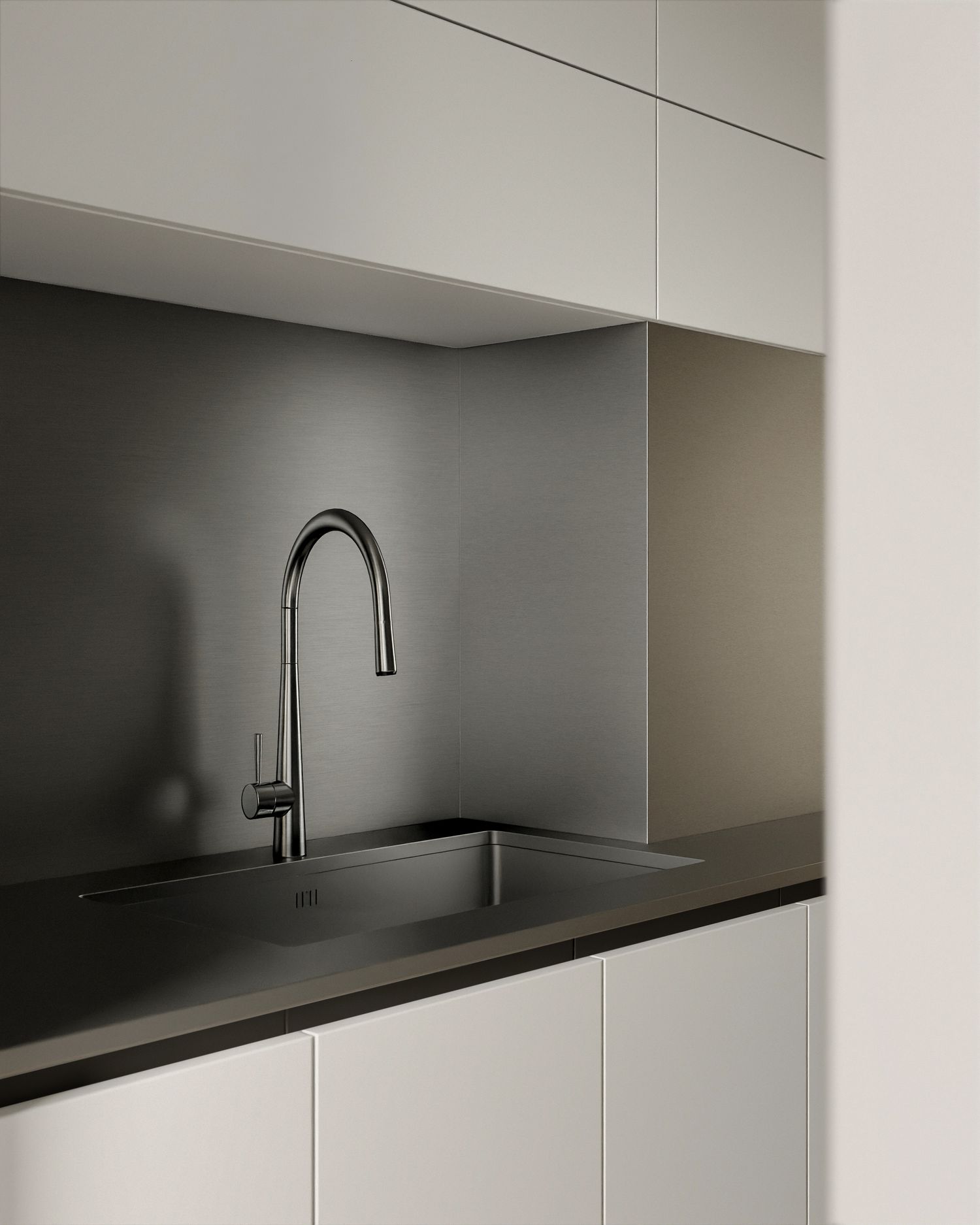Minimalist kitchen with dark undermount sink, sleek pull-down faucet, dark backsplash, and white cabinetry.