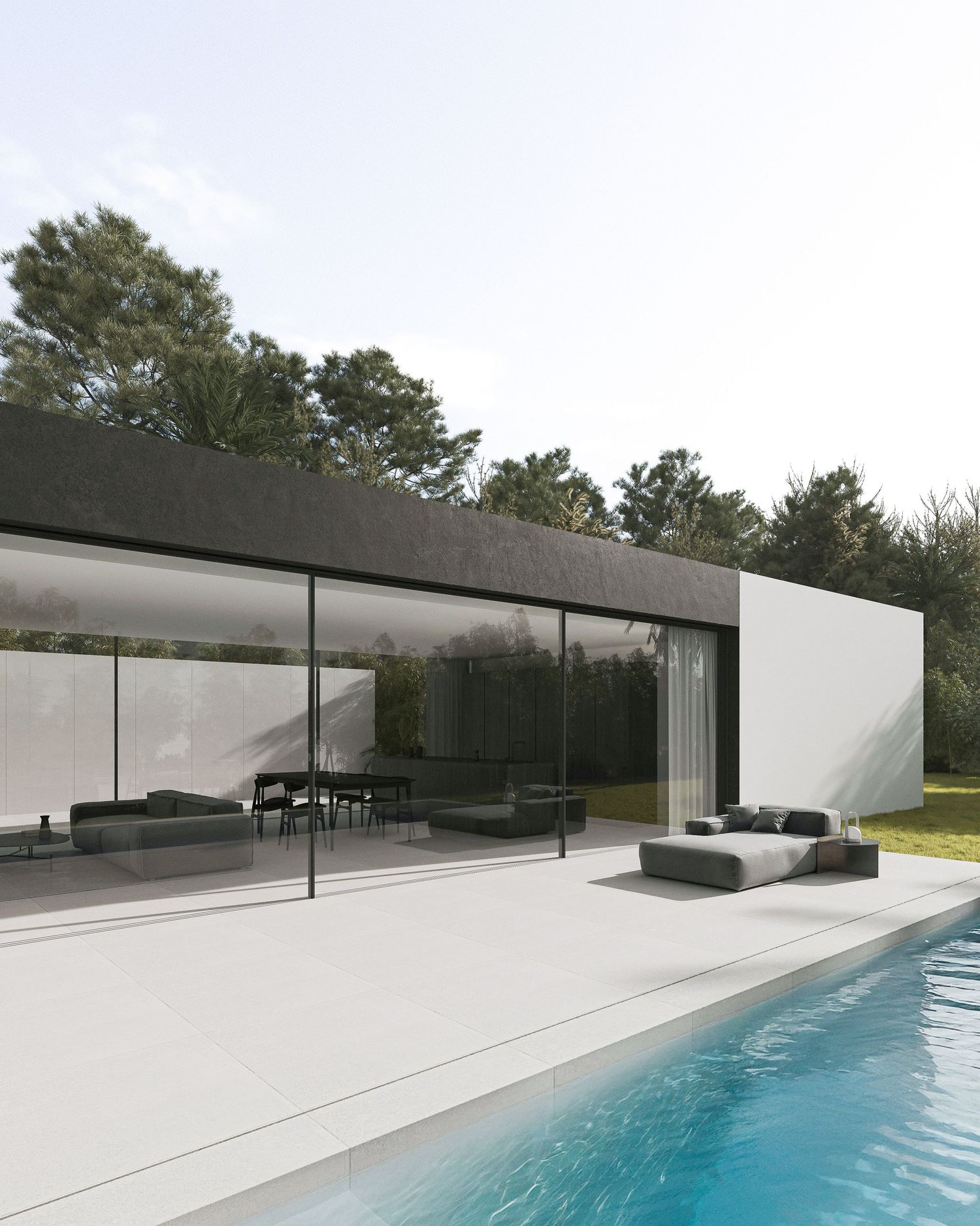 Modern minimalist villa with floor-to-ceiling glass walls and luxurious swimming pool showcasing sleek architectural design.