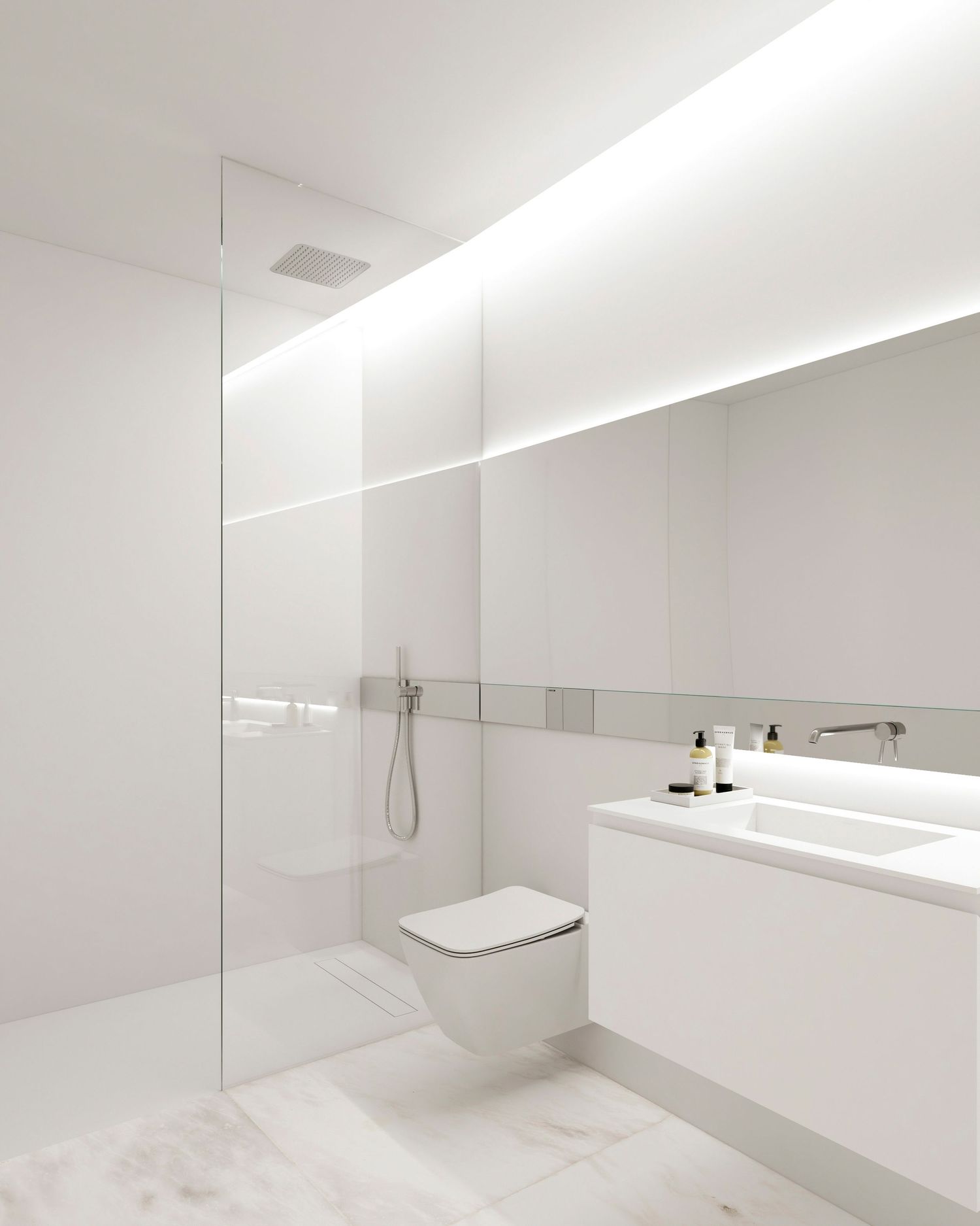 Minimalist white bathroom with floating vanity, wall-mounted toilet and seamless glass shower partition featuring LED lighting.