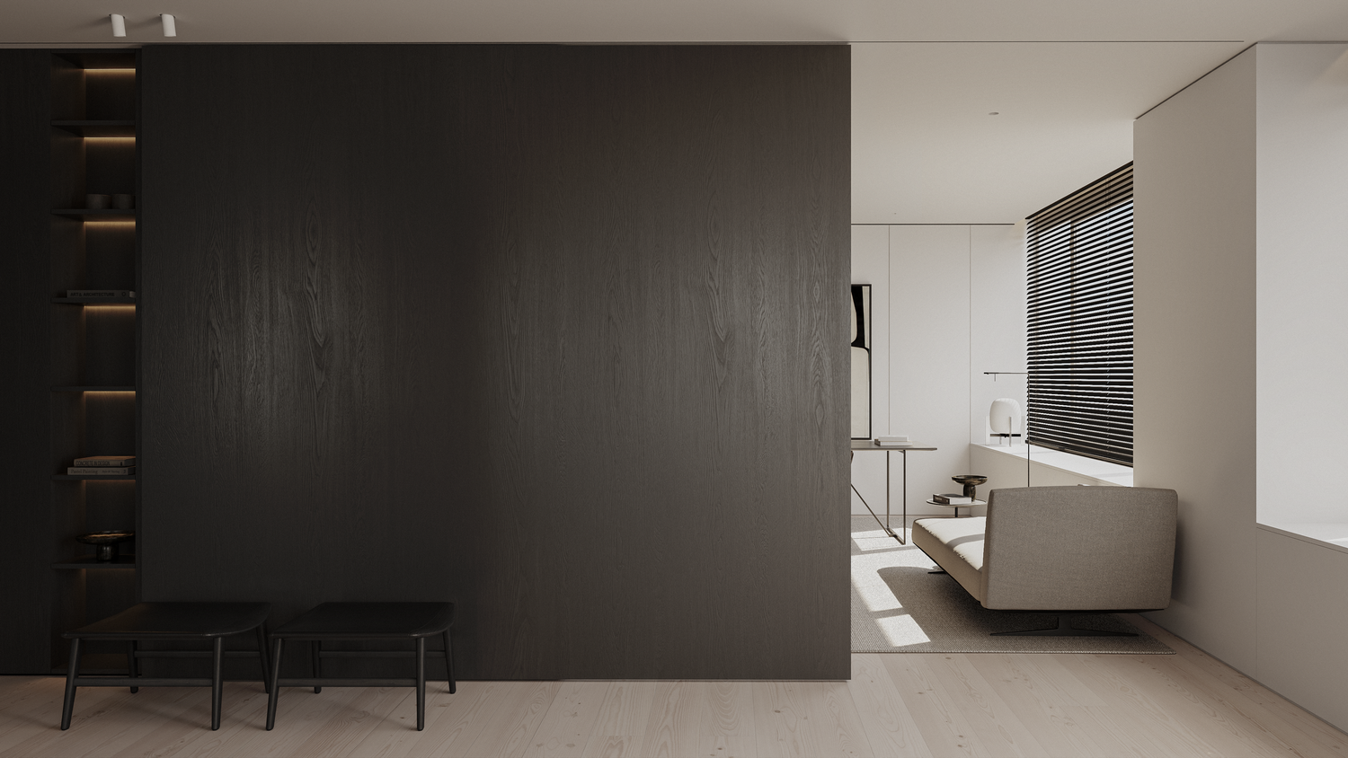 Minimalist interior with dark wood accent wall, built-in shelving, black bench, and bright living area with sofa and window.