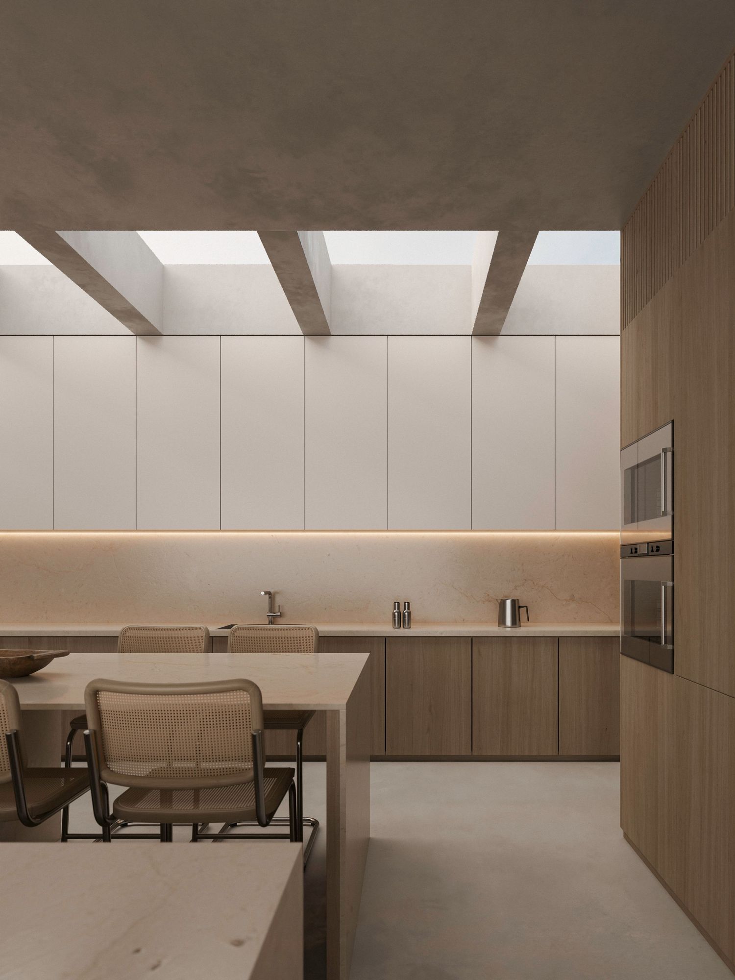 Modern minimalist kitchen interior with sleek wooden cabinets, integrated appliances and dining area under recessed lighting.