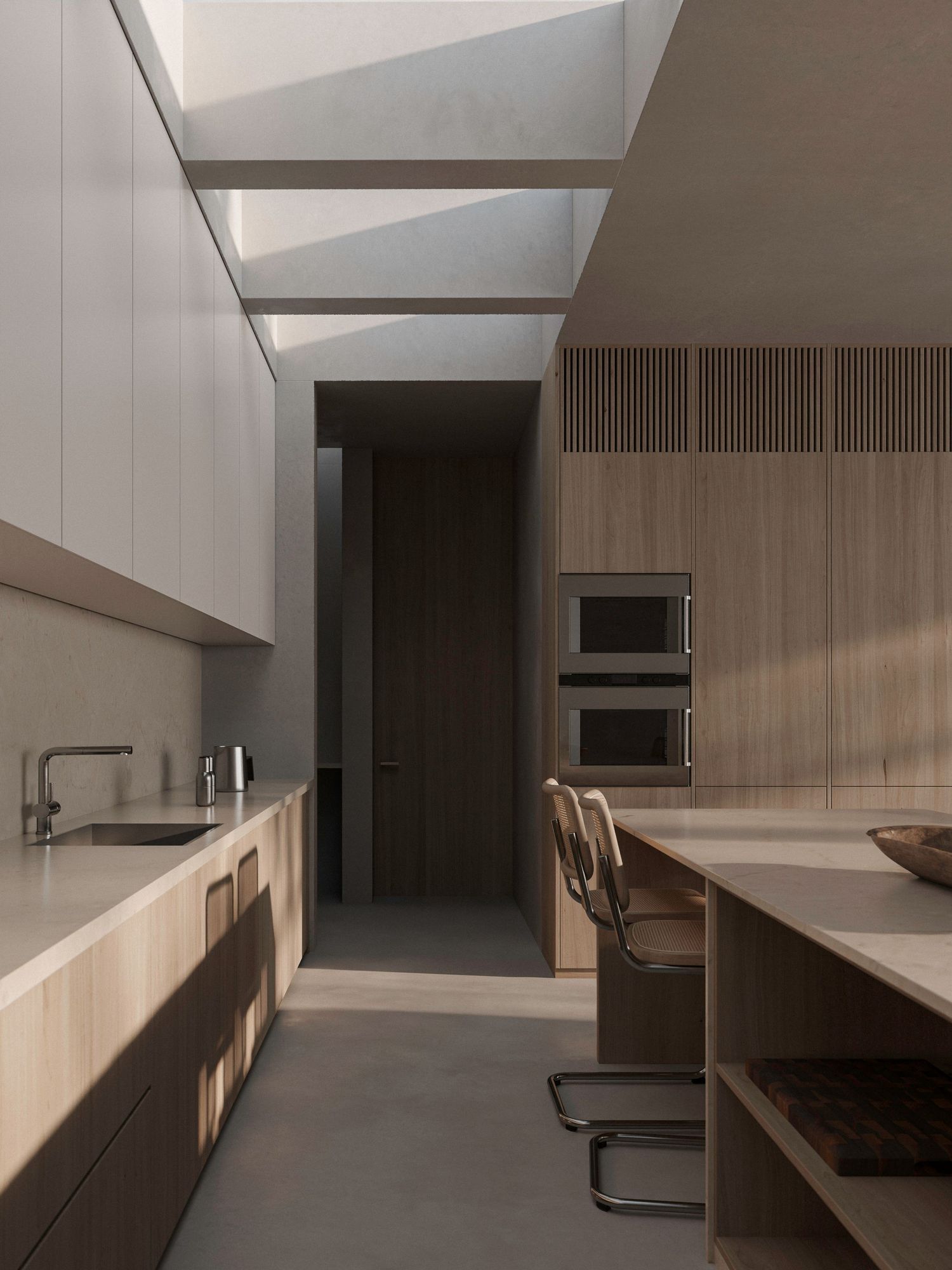 Modern minimalist kitchen with wooden cabinetry, sleek appliances, and a skylight illuminating the neutral-toned space.