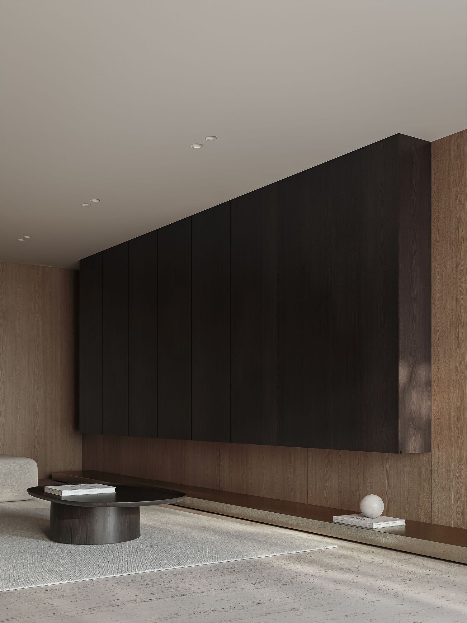 A minimalist modern interior with dark wood paneling, wood walls, and a low circular coffee table on a textured carpet.