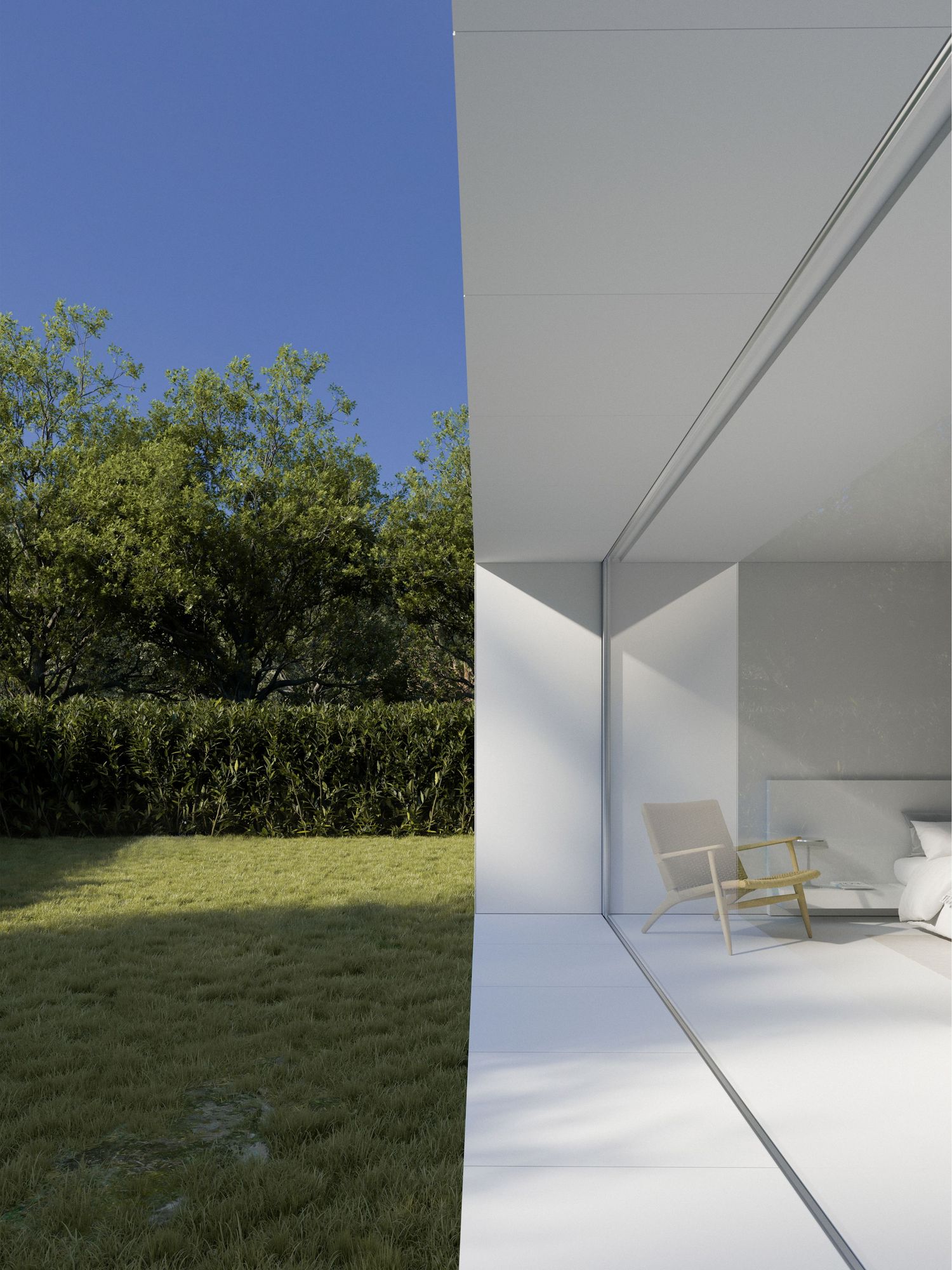 Modern minimalist interior space with floor-to-ceiling glass window overlooking a green garden with trees and hedges.