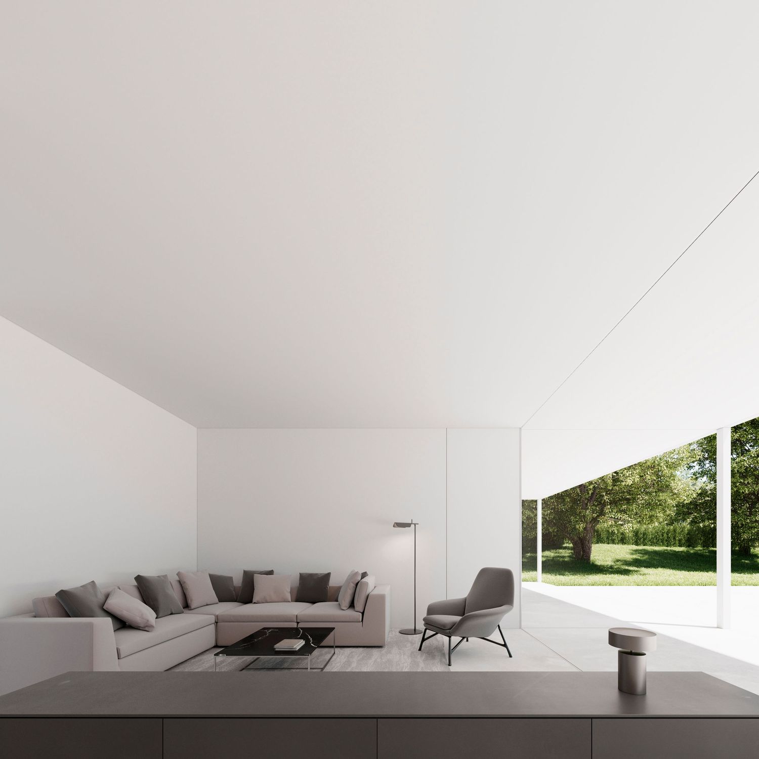 Minimalist white living room with gray sectional sofa and large window overlooking garden.