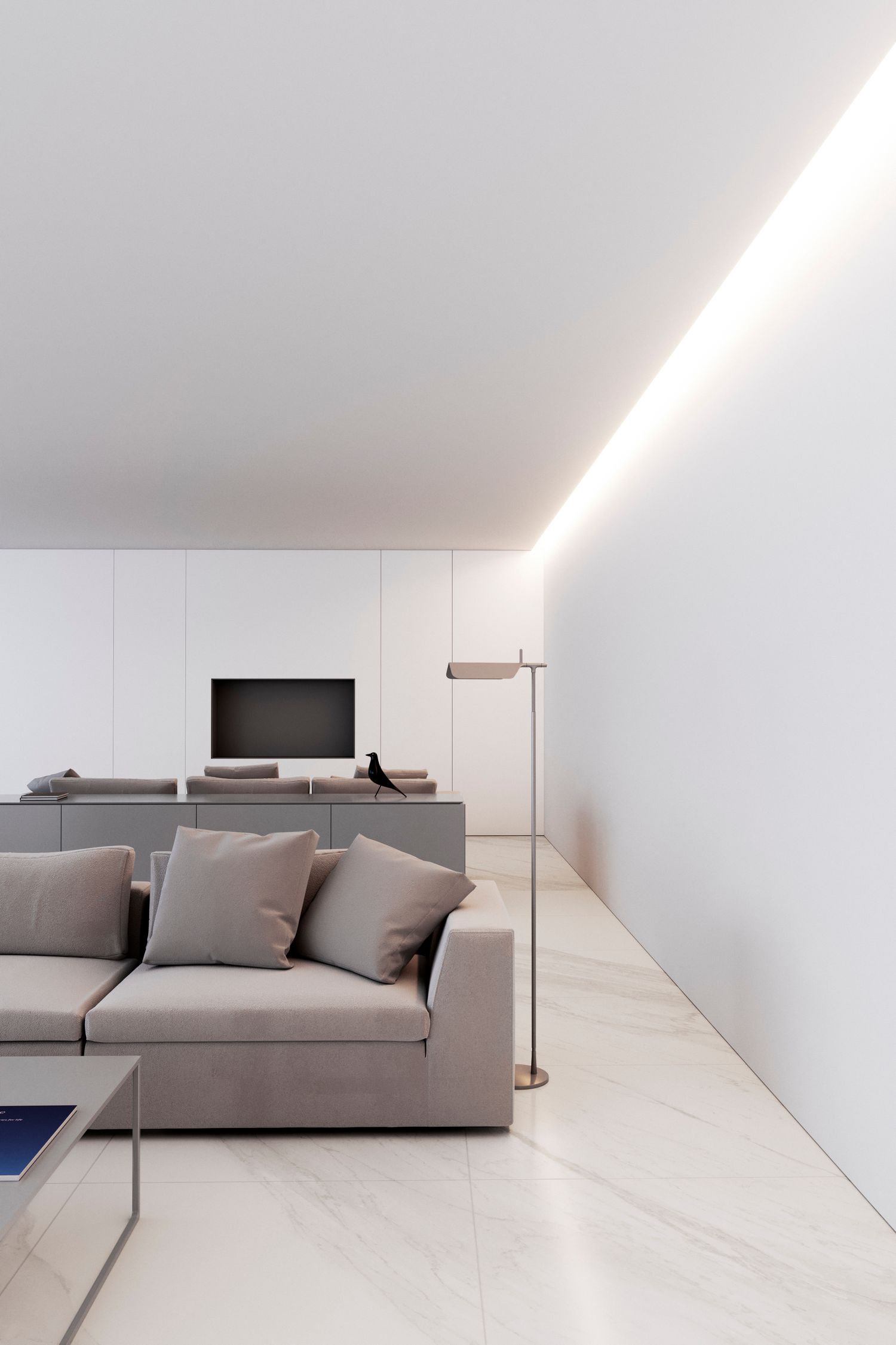 Minimalist living room with grey sofa and built-in media center featuring ambient lighting.