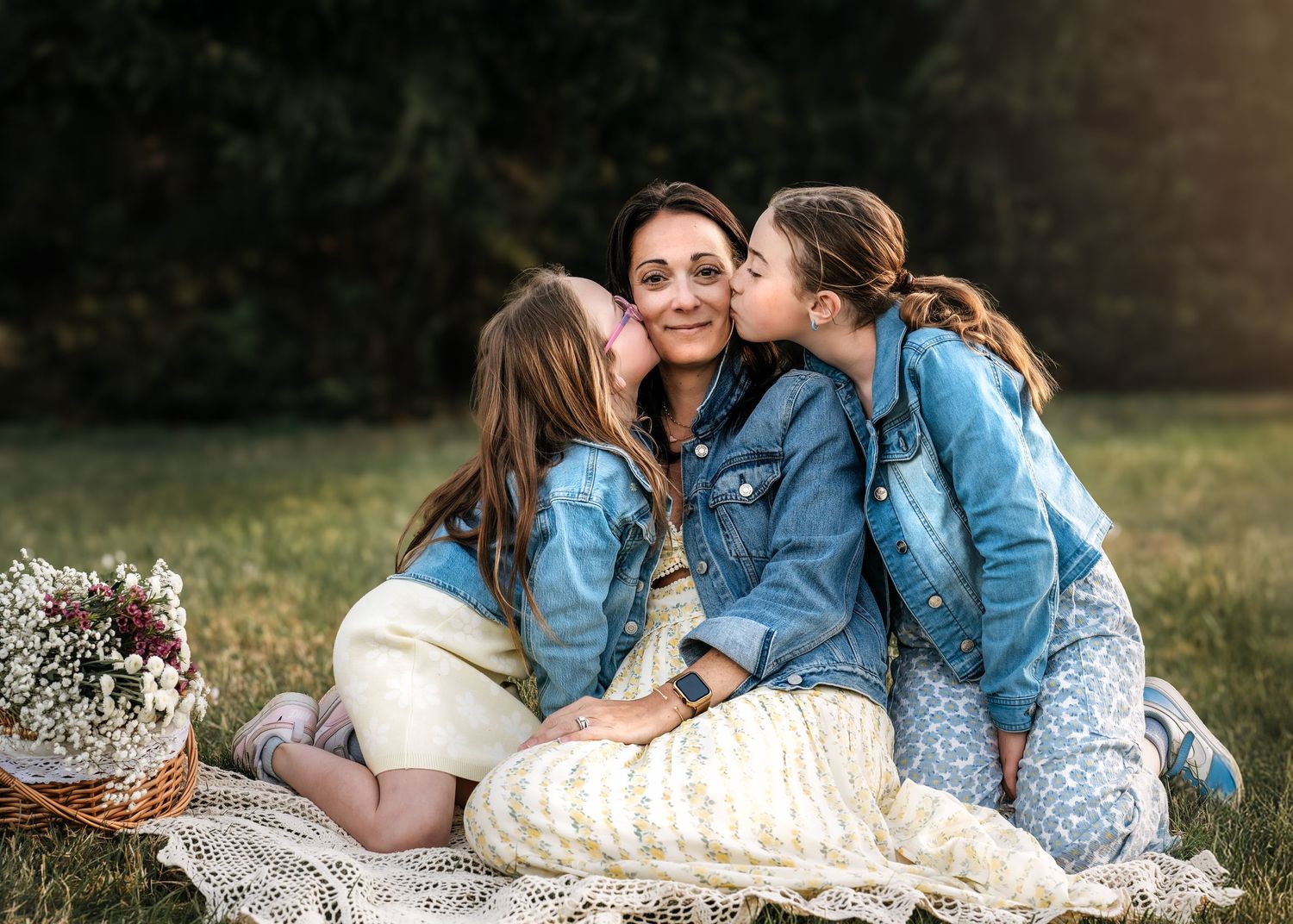 A mother with her two daughters during a playful moment at an outdoor Mommy & Me portrait session near Wayne, PA.