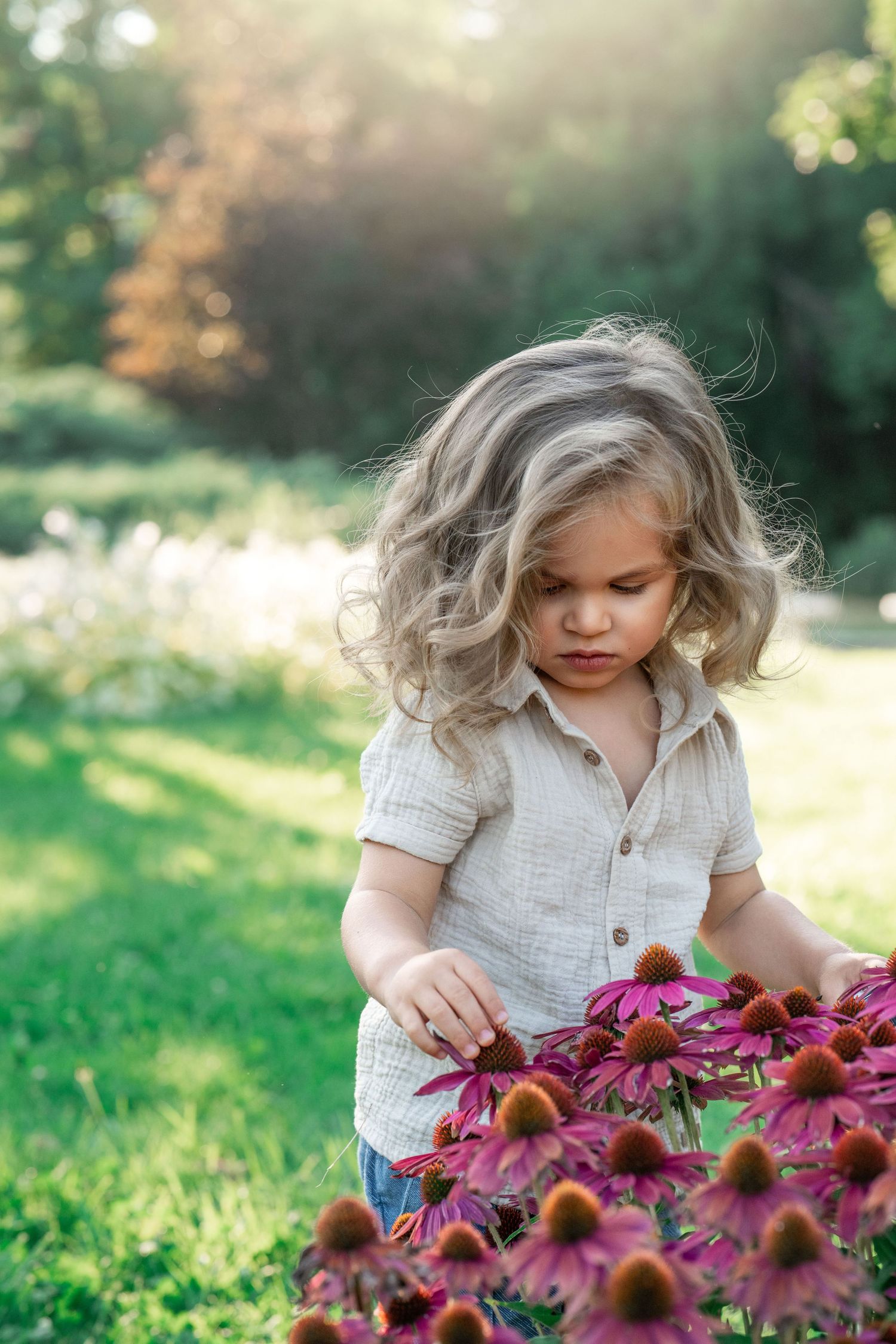 Young child with flowers during a family portrait session on the Main Line, PA.