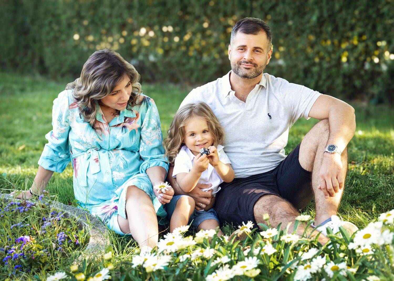 Happy family photographed outside during their family photo session on the Main Line, PA.