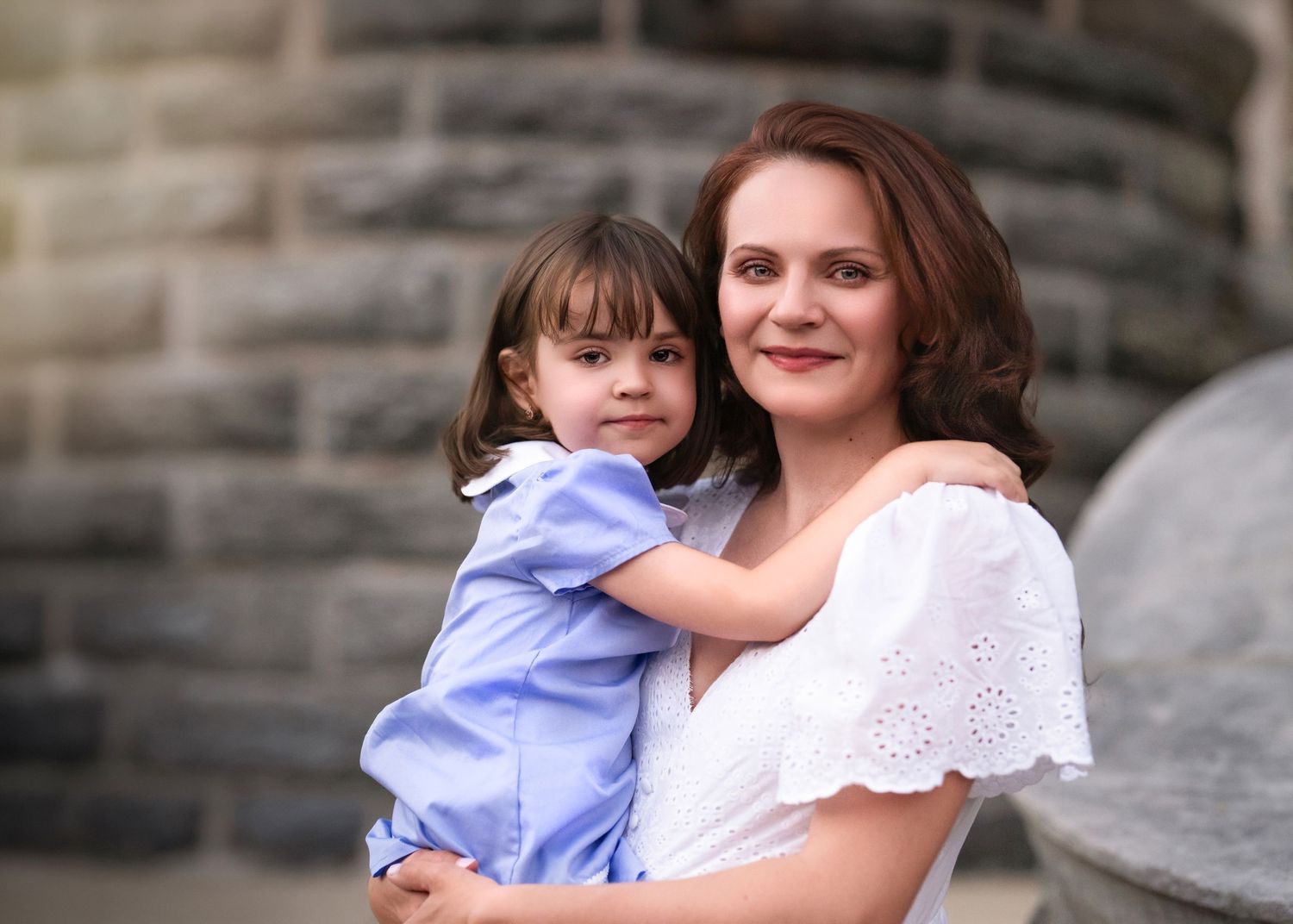 A mother holding her young daughter during their golden hour Mommy & Me portrait session near the Main Line PA.