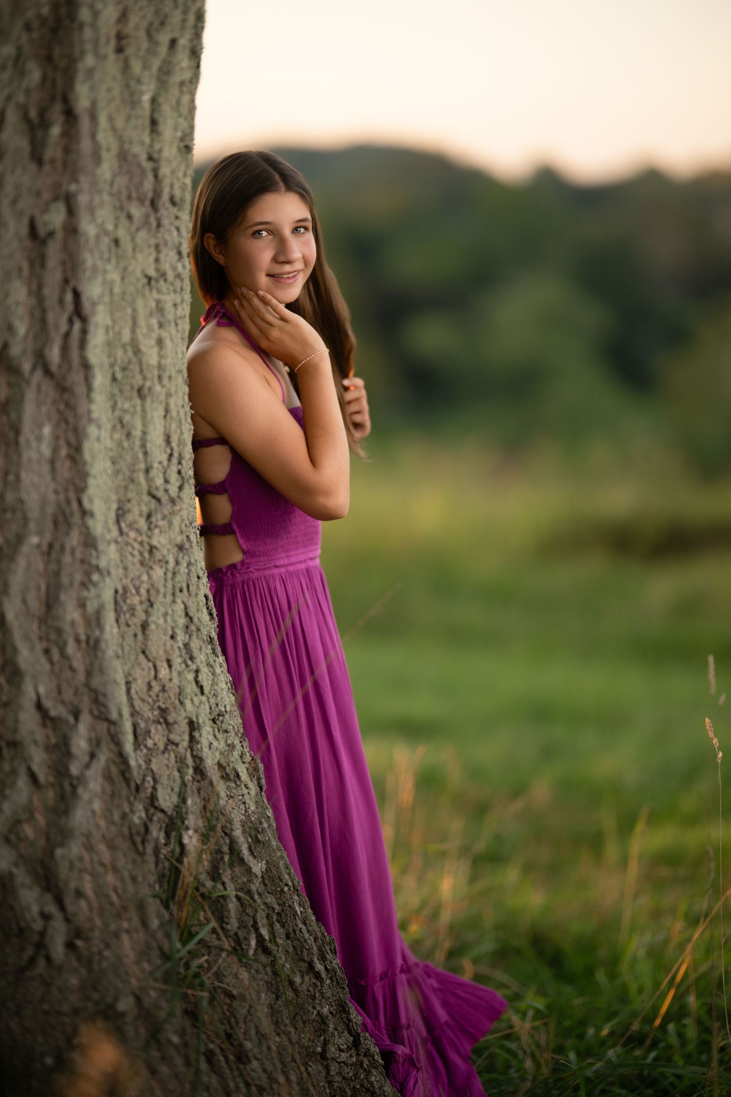 Senior portrait by a tree in a sunlit field during a Main Line, PA high school senior photography session.