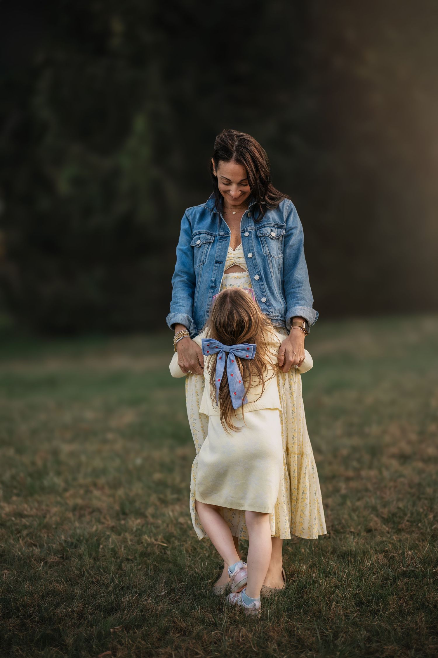 Mother and daughter holding hands during an outdoor Mommy & Me photography session on the Main Line, PA.