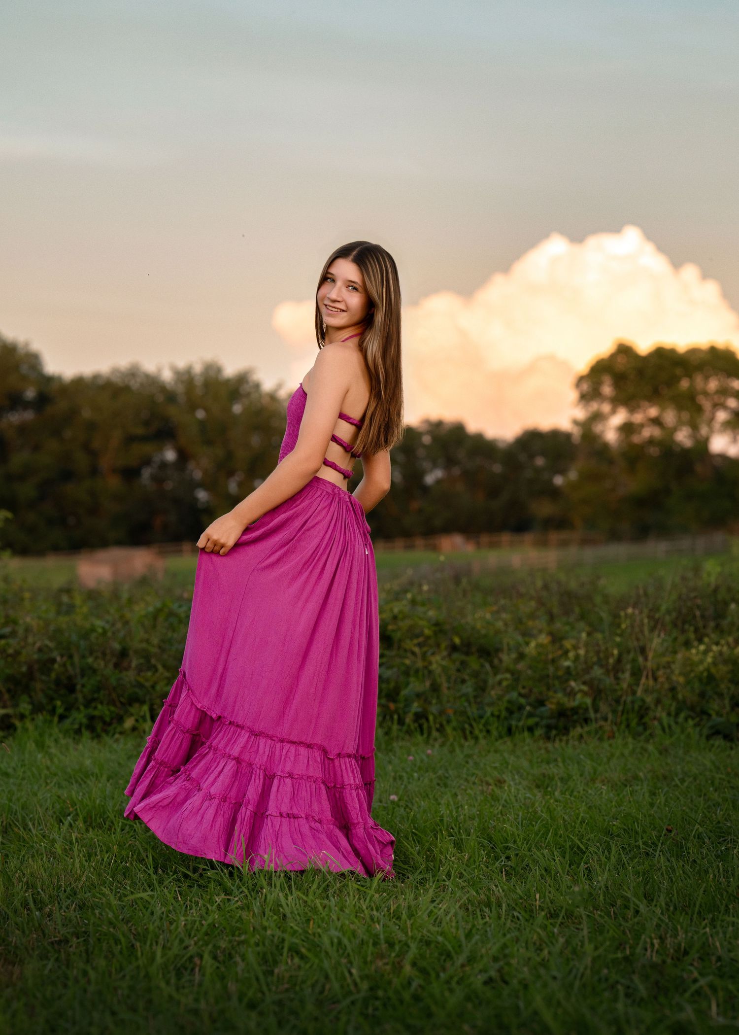 High school senior portrait in a flowing magenta dress during an outdoor photography session near Wayne, PA.