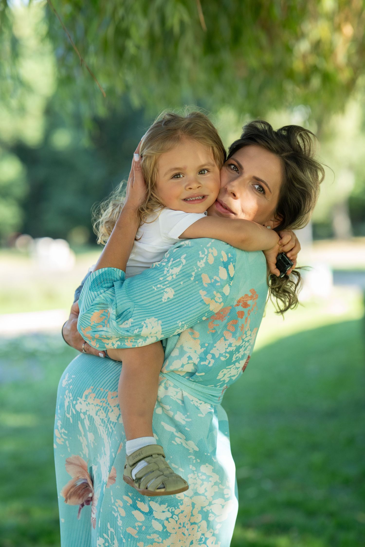 Mother embracing her child during an outdoor Mommy & Me portrait session on the Main Line, PA.
