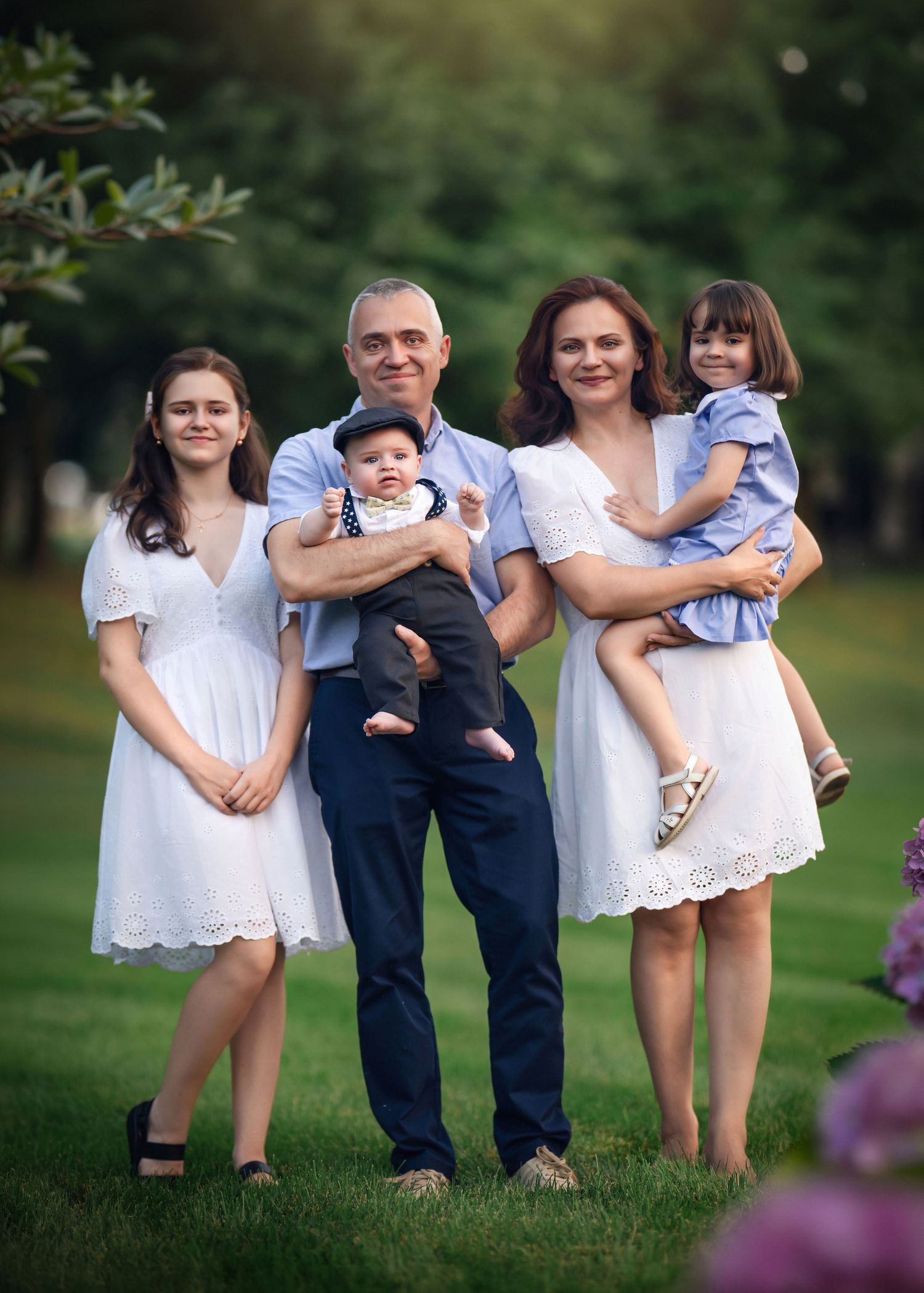 Happy family of five posing outdoors during their family portrait session on the Main Line, PA.