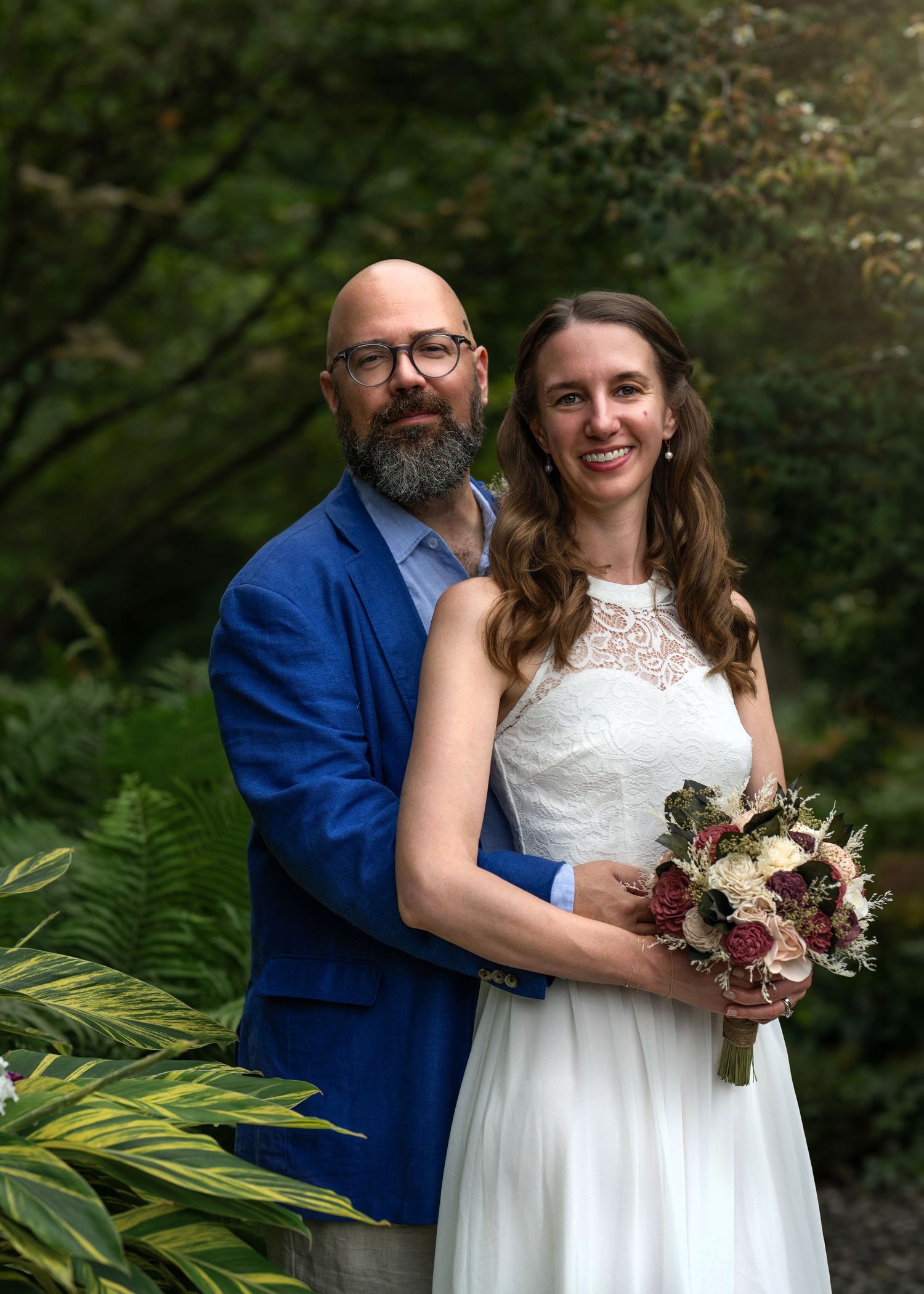 Bride and groom posing with their wedding bouquet during intimate wedding photography on the Main Line.