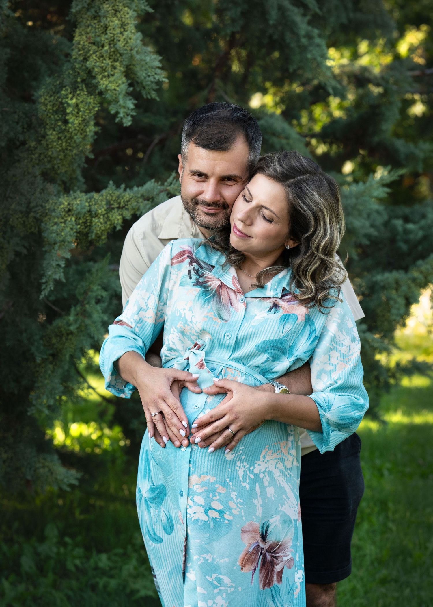 Expectant couple embracing during an outdoor maternity photography session near Wayne, PA.