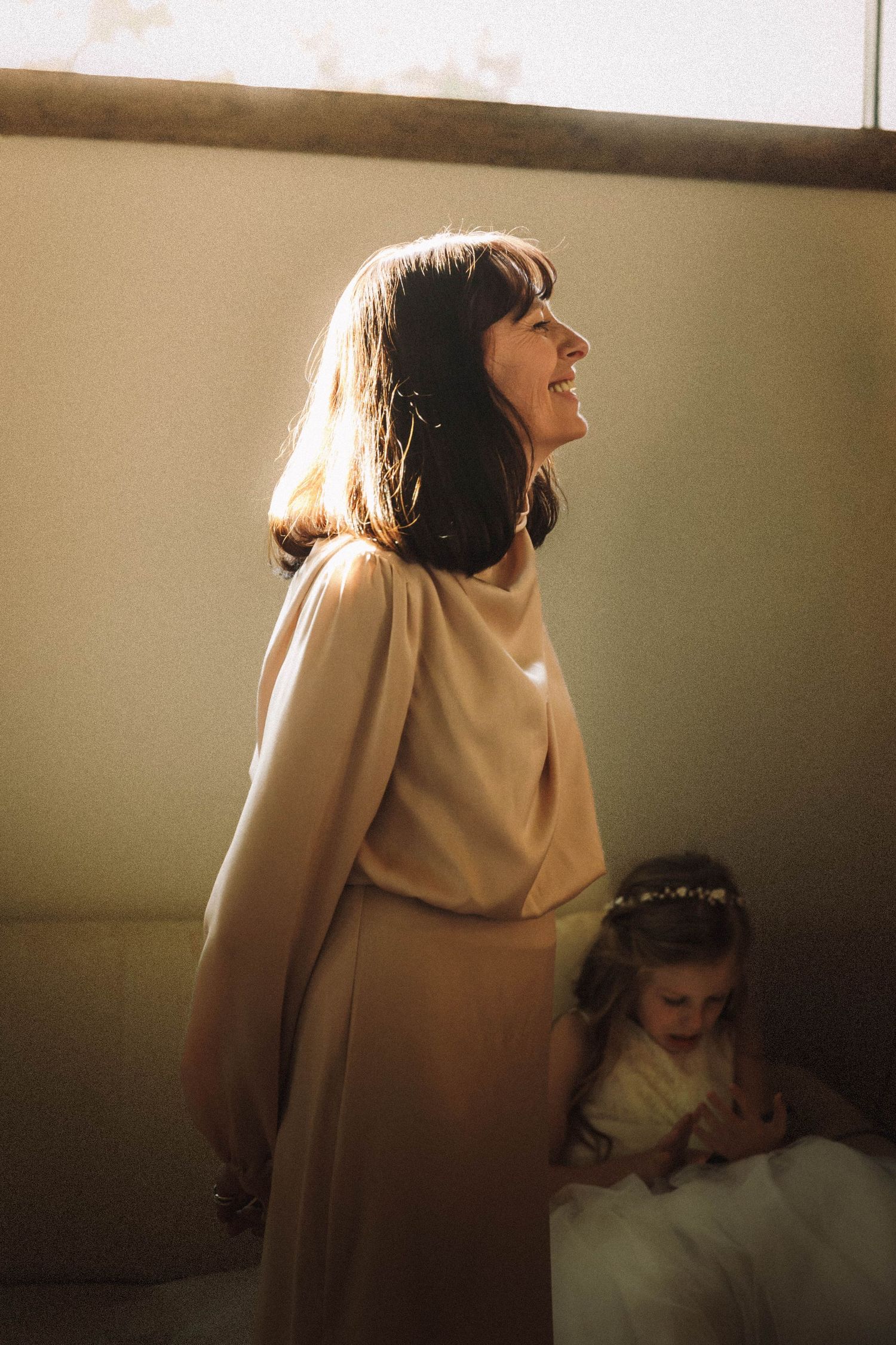 Silhouettes of a standing figure illuminated in warm sepia tones with dramatic lighting creating moody atmosphere.