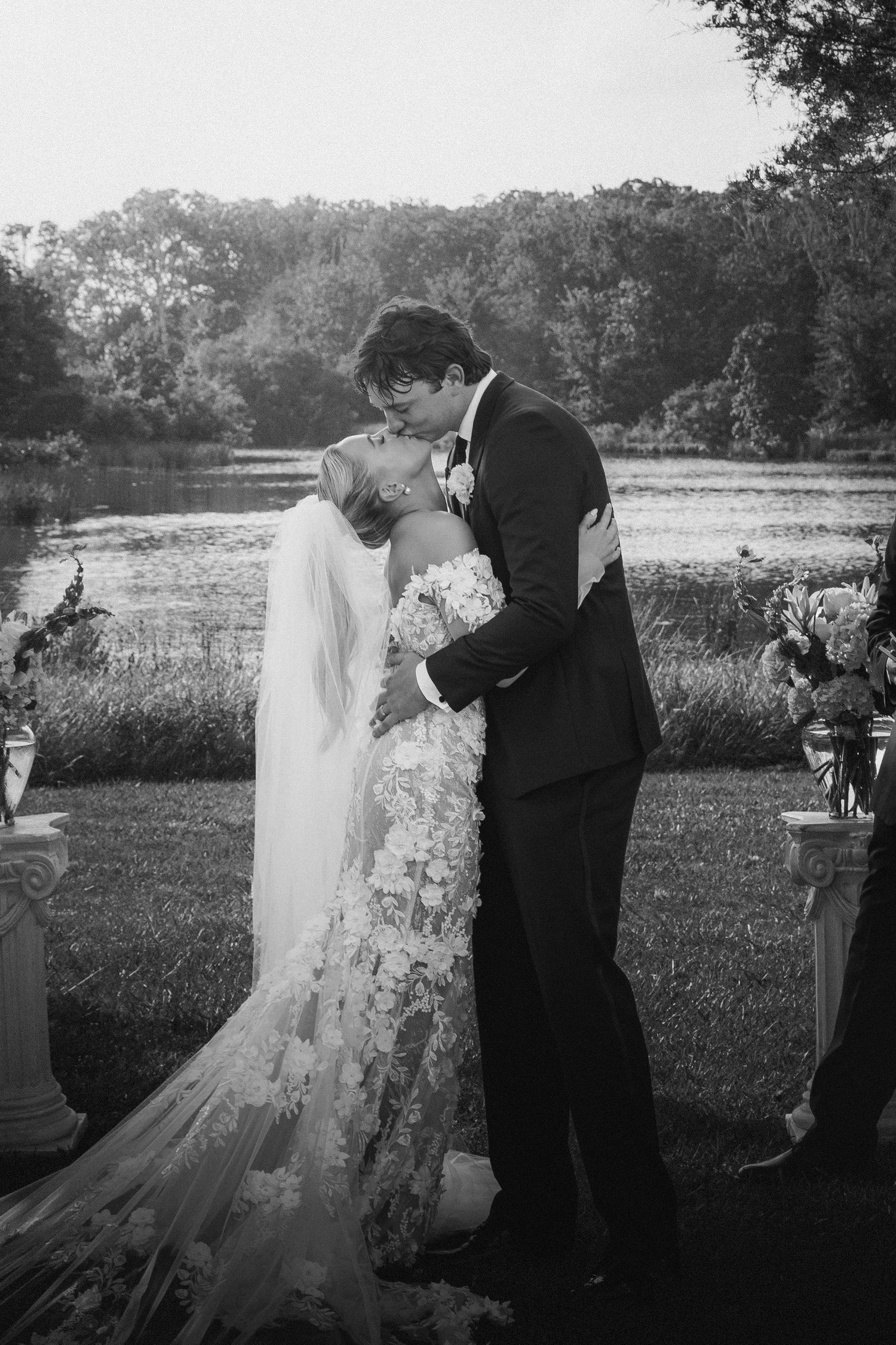 Black and white wedding photography captures intimate moment between couple.