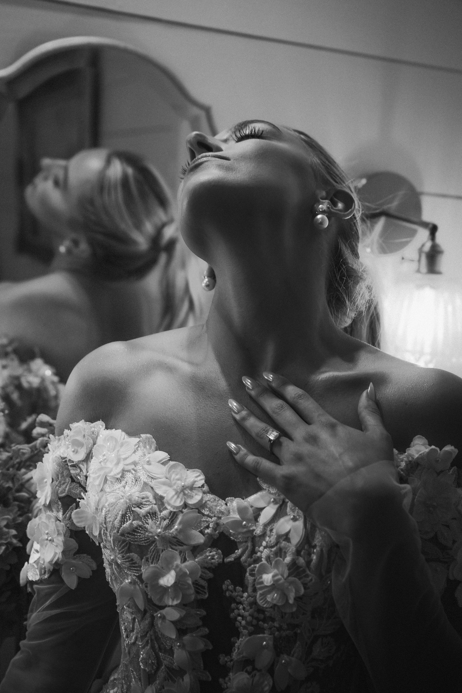 Black and white romantic sequence of loving couple in soft focus kissing with a delicate bouquet nearby.