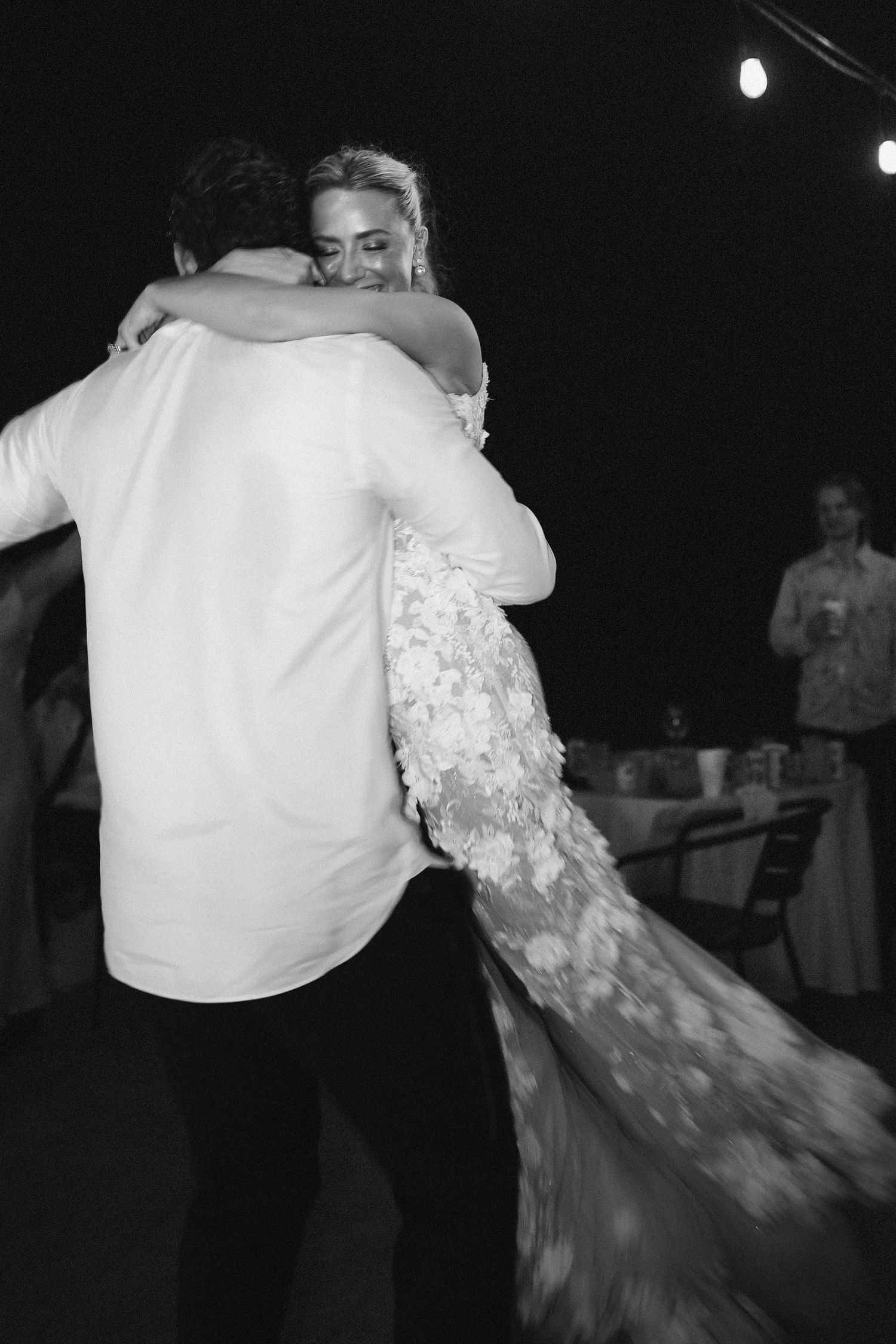 A black and white photo of couples dancing at a wedding reception.