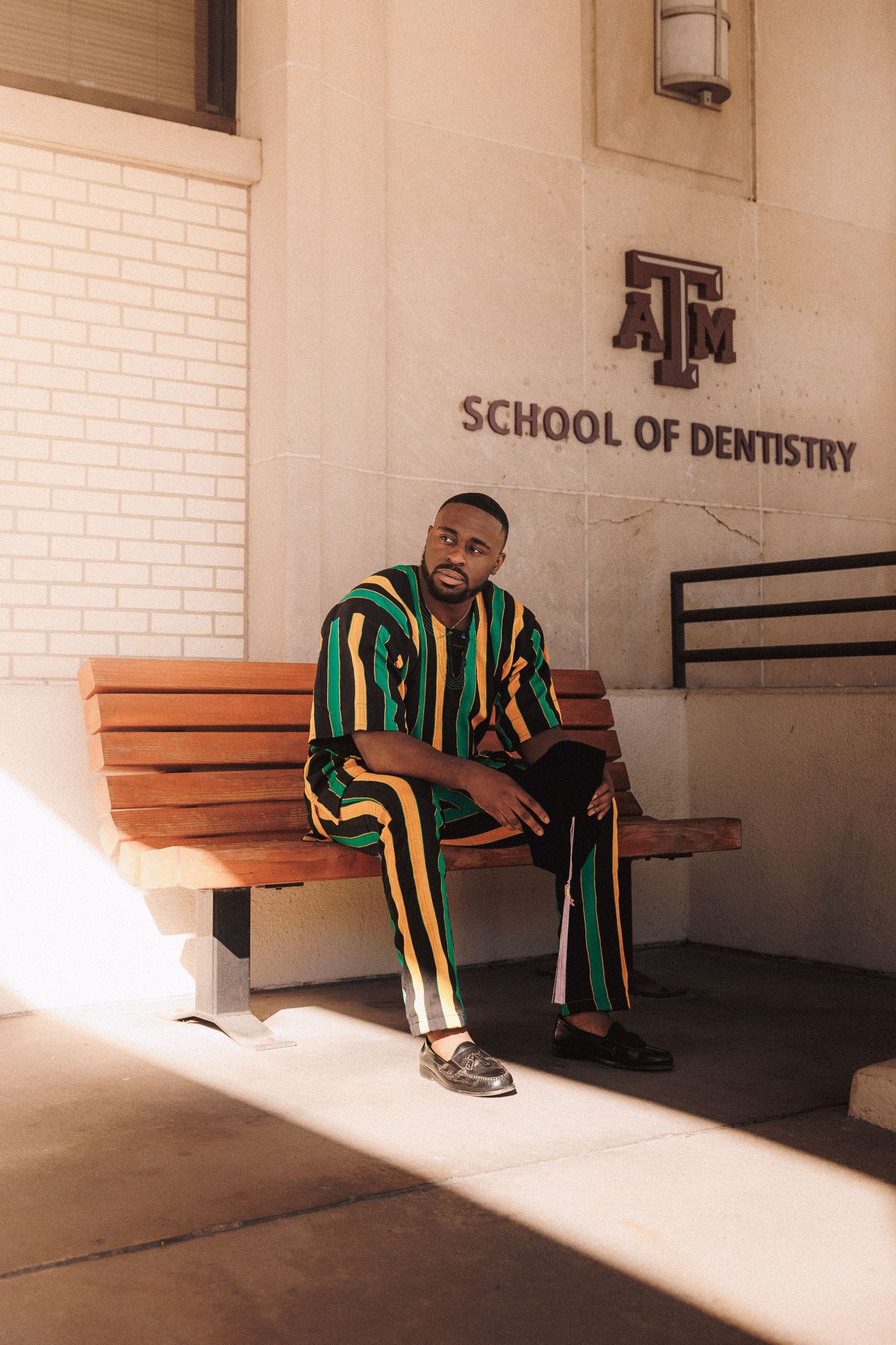 Four sequential shots of someone sitting on a bench in graduation regalia with warm sunlight streaming in through windows.