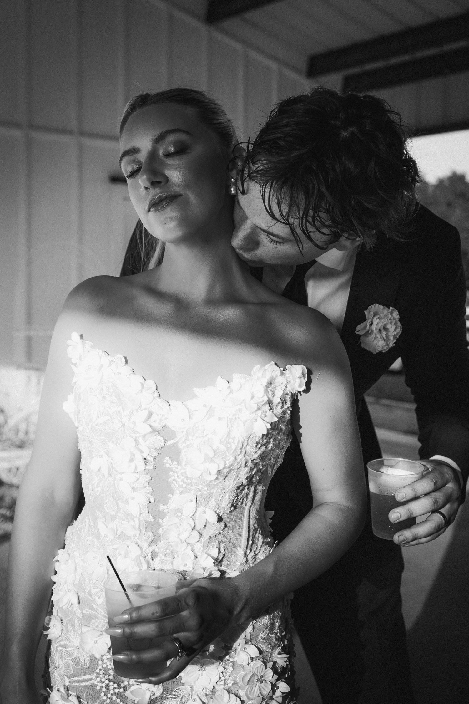 Black and white intimate wedding photos capturing tender moments in dramatic lighting.