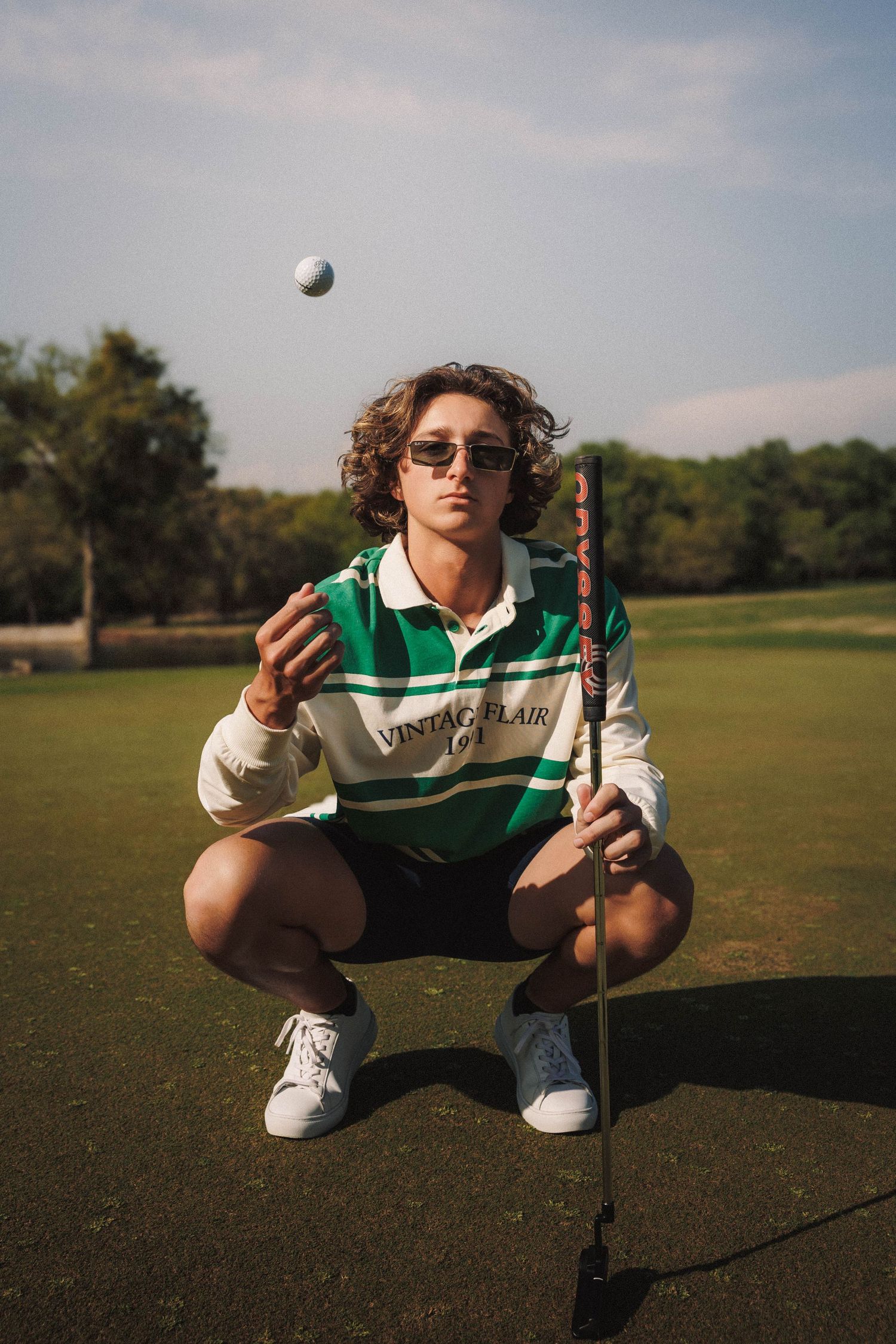 A sequence of photos showing a golf ball being juggled and tossed in the air on a sunny golf course.