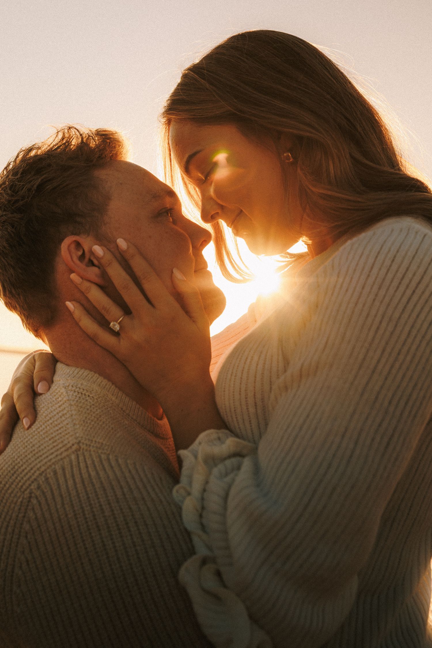 A romantic couple embracing and kissing in silhouette against warm sunlight in a sequence of intimate moments.