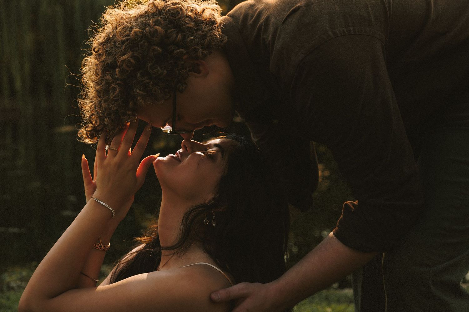 An intimate moment captured in warm sunset lighting with natural scenery.