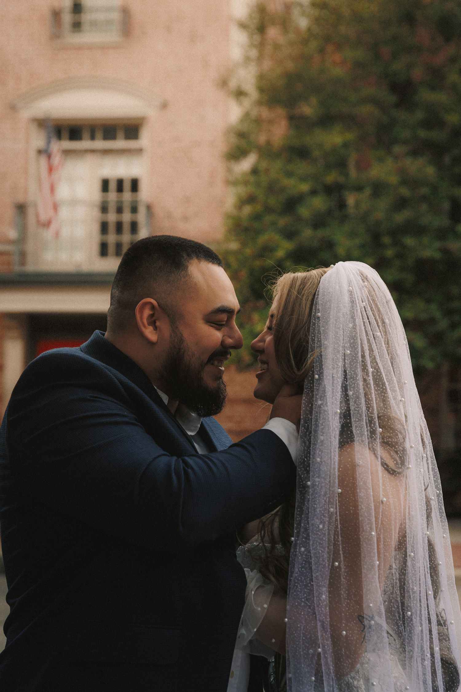 A romantic wedding sequence showing a couple sharing intimate moments in front of a building.