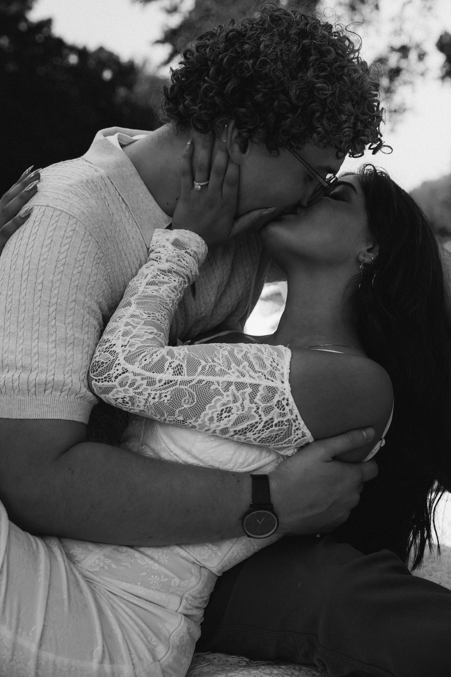 A romantic black and white photo sequence shows an intimate embrace between two people in white clothing.