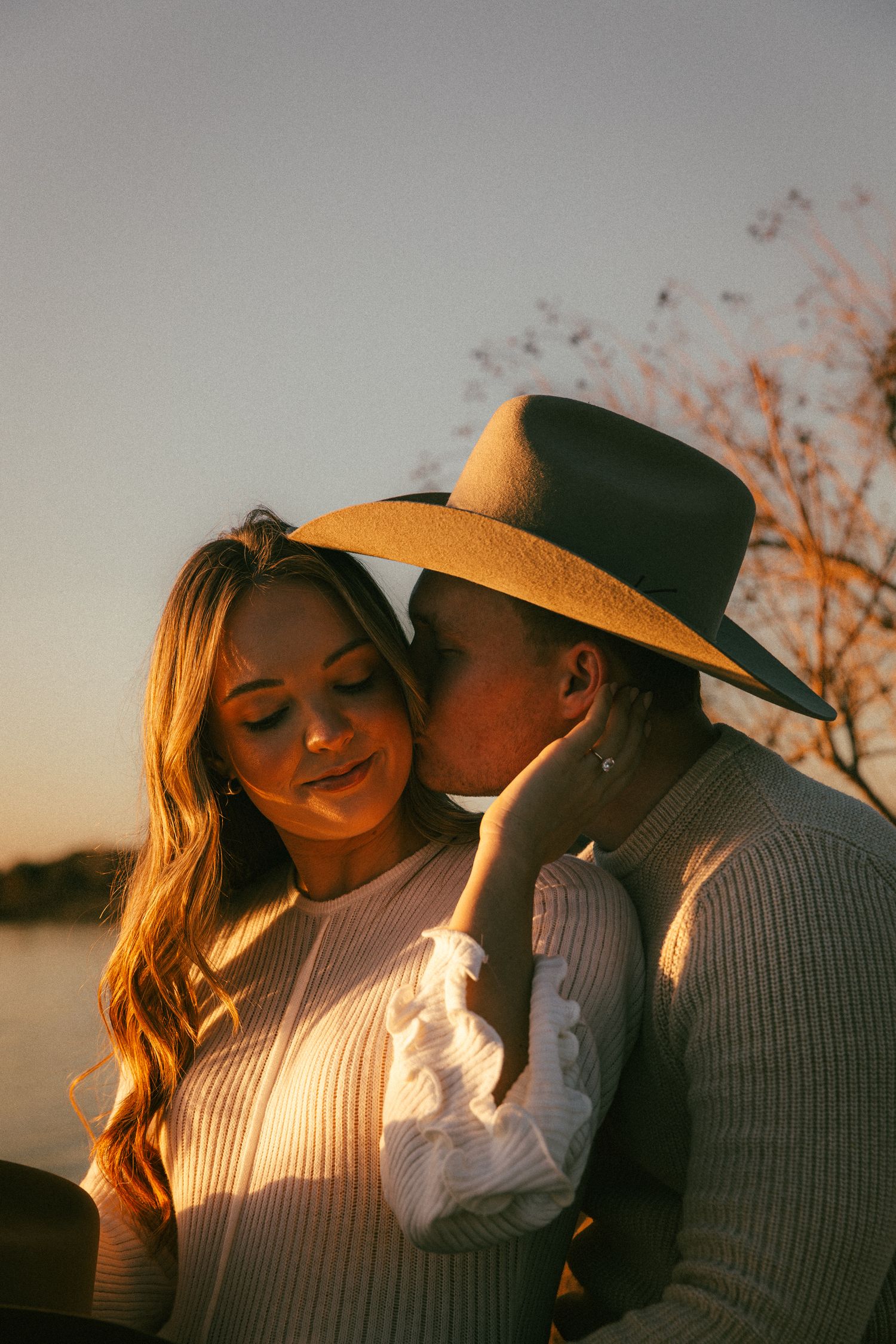 A romantic couple shares intimate moments at sunset in a series of close-up shots.