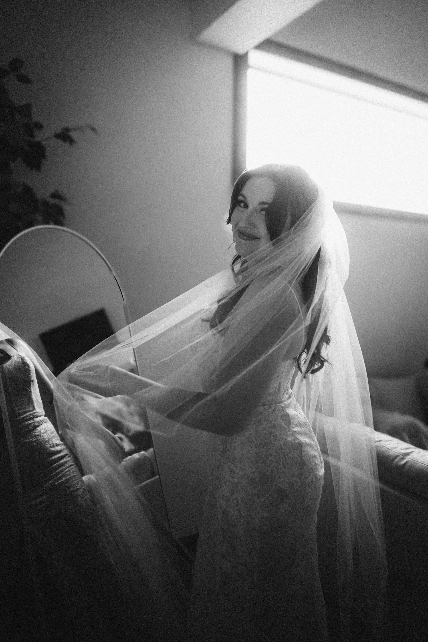 A haunting black and white sequence of a person wearing a ghostly veil in dramatic lighting, creating an ethereal atmosphere.