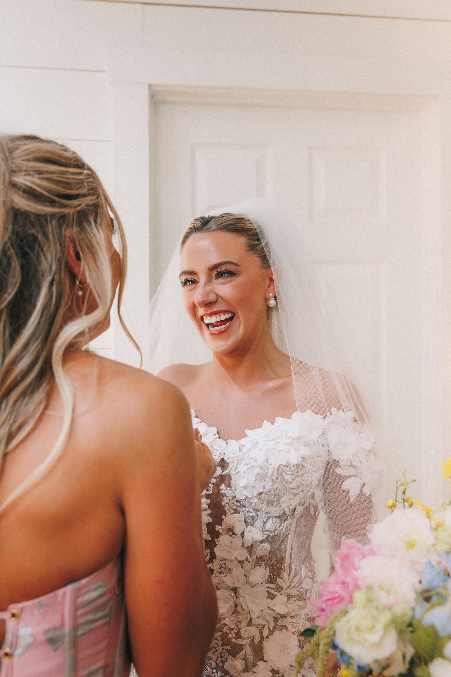 Intimate wedding photography moment with white floral details and bouquet.