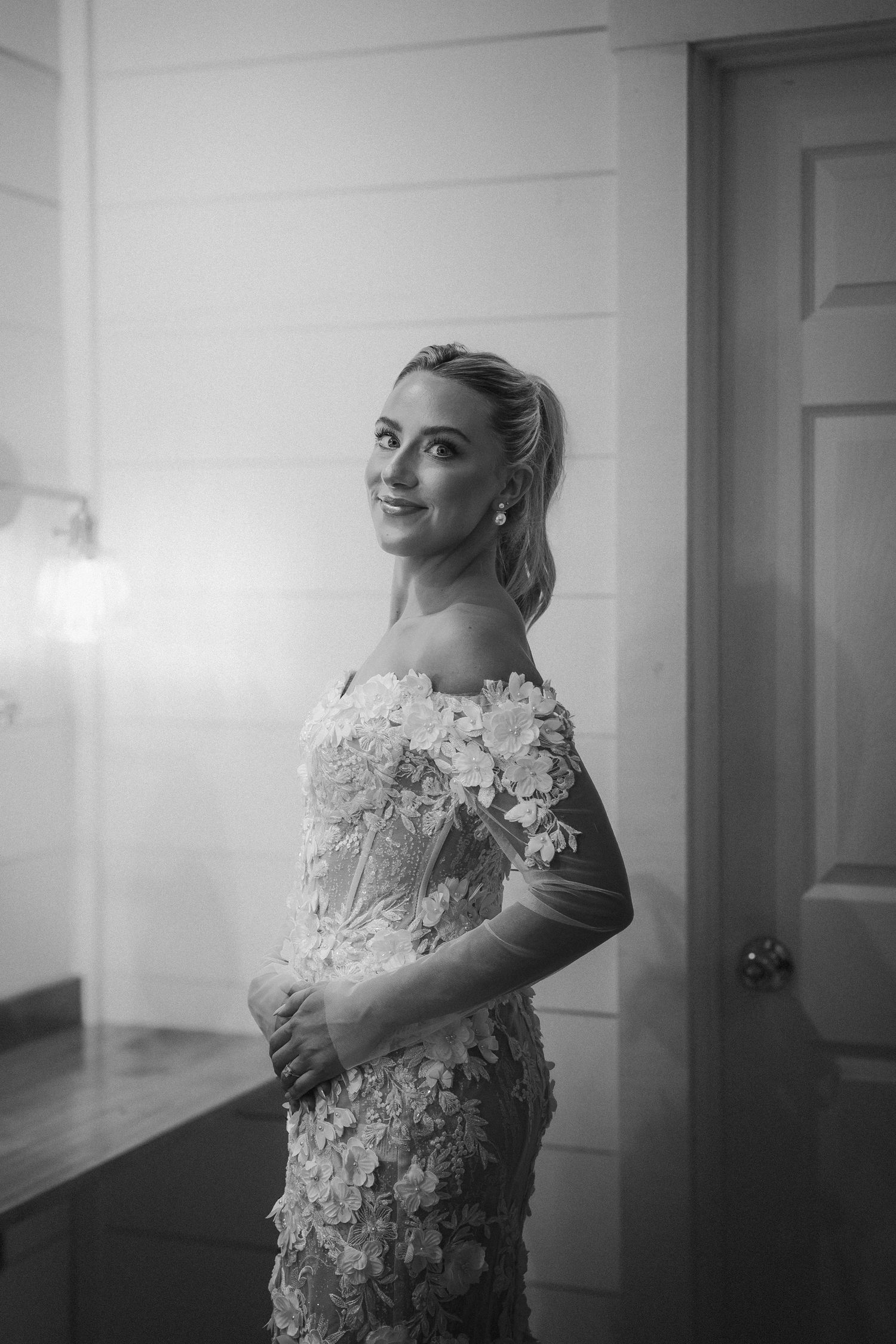 Black and white bridal portrait showcasing detailed lace wedding dress.