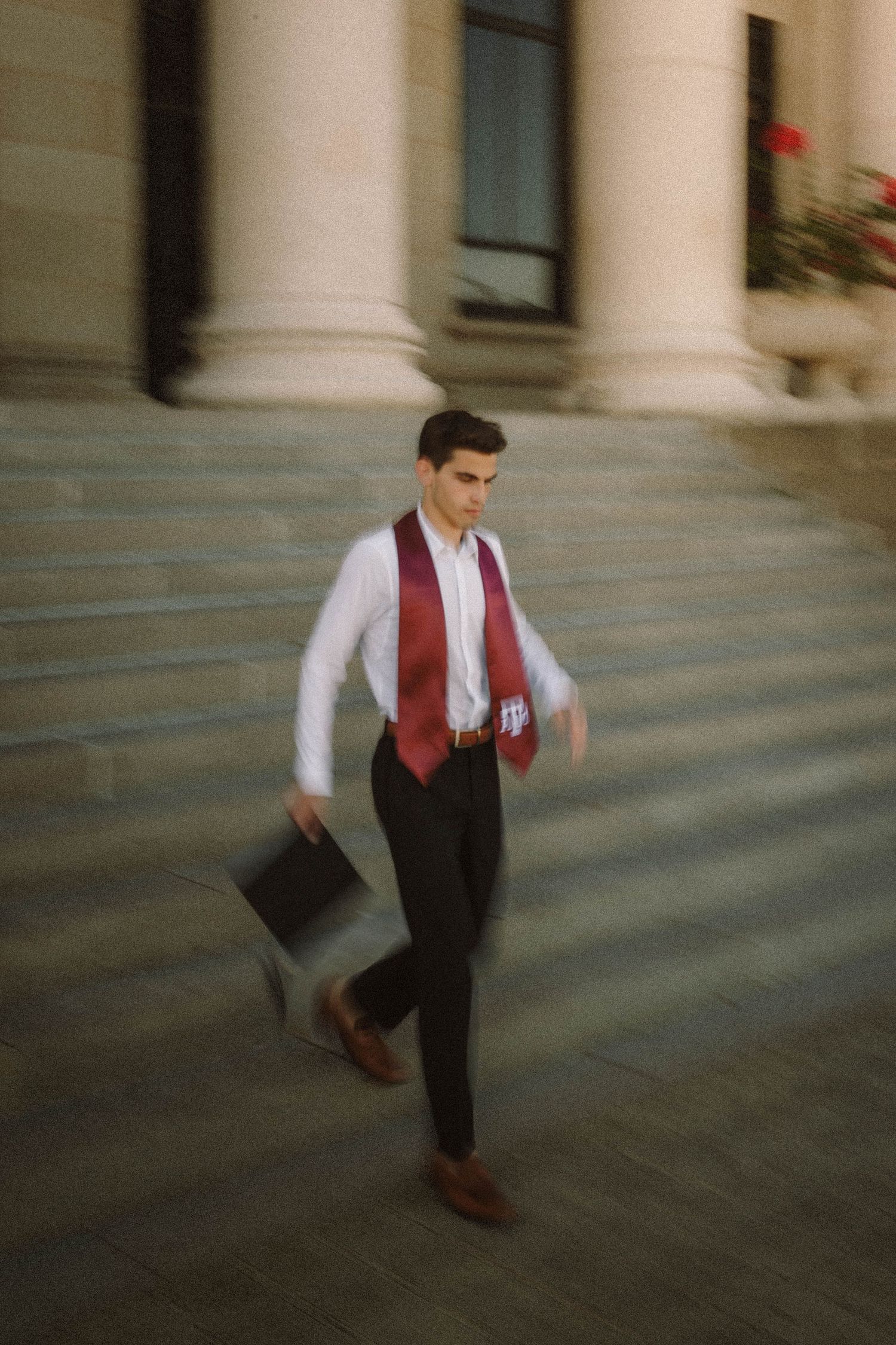 A motion-blurred sequence shows someone in a burgundy vest and white shirt walking down stone steps.
