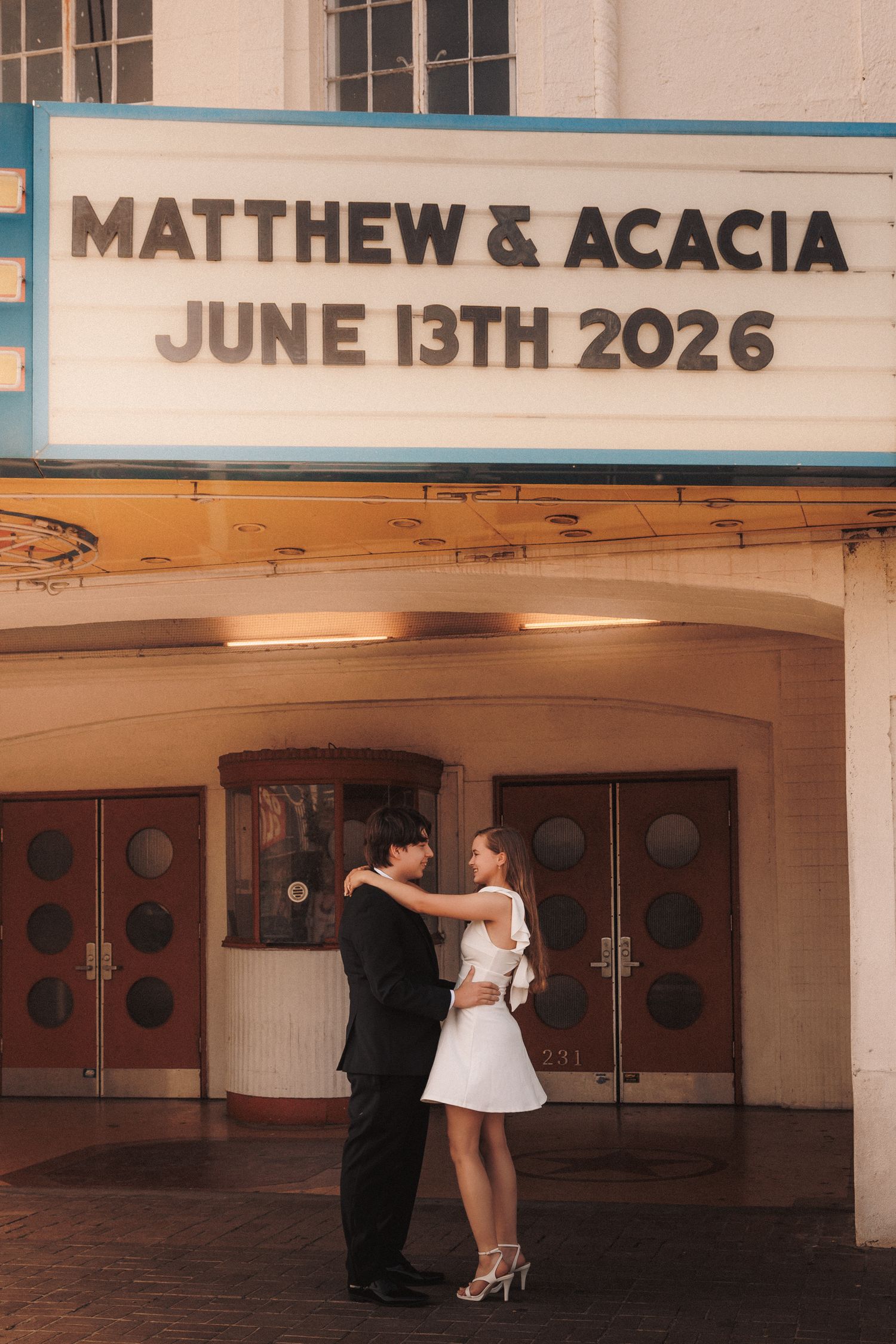 A wedding engagement photo sequence showing a couple spinning and dancing together in an empty vintage theater lobby.