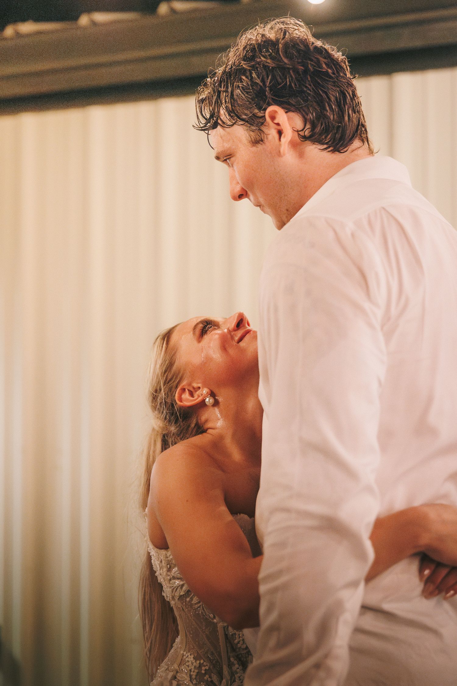 Intimate dance moment captured between two people at an evening wedding reception.