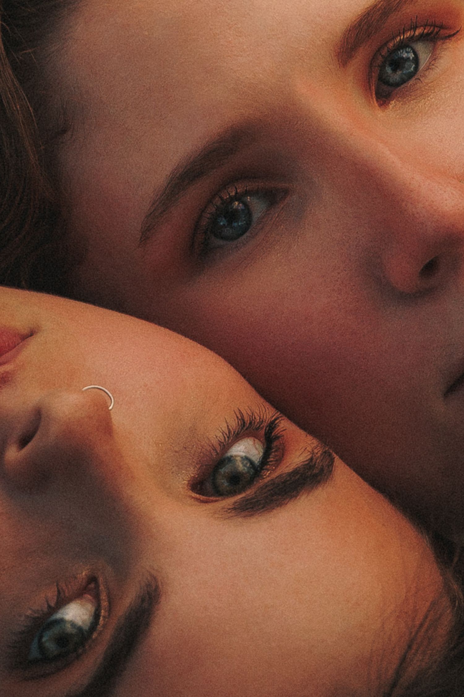 Artistic close-up portrait shot with dramatic lighting and warm tones.