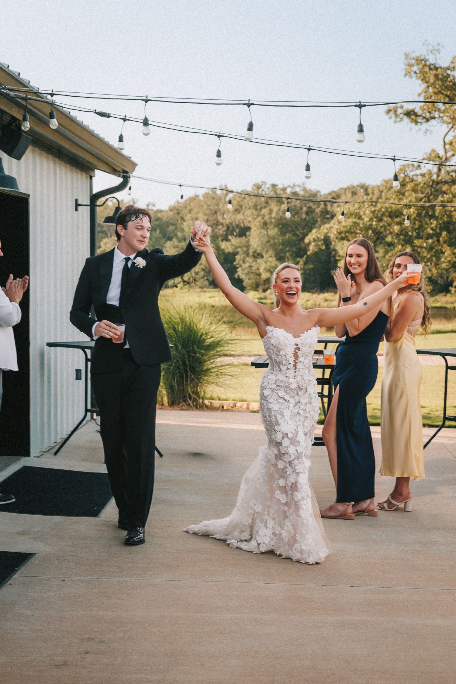 A celebratory moment on the dance floor as wedding guests cheer during the reception.