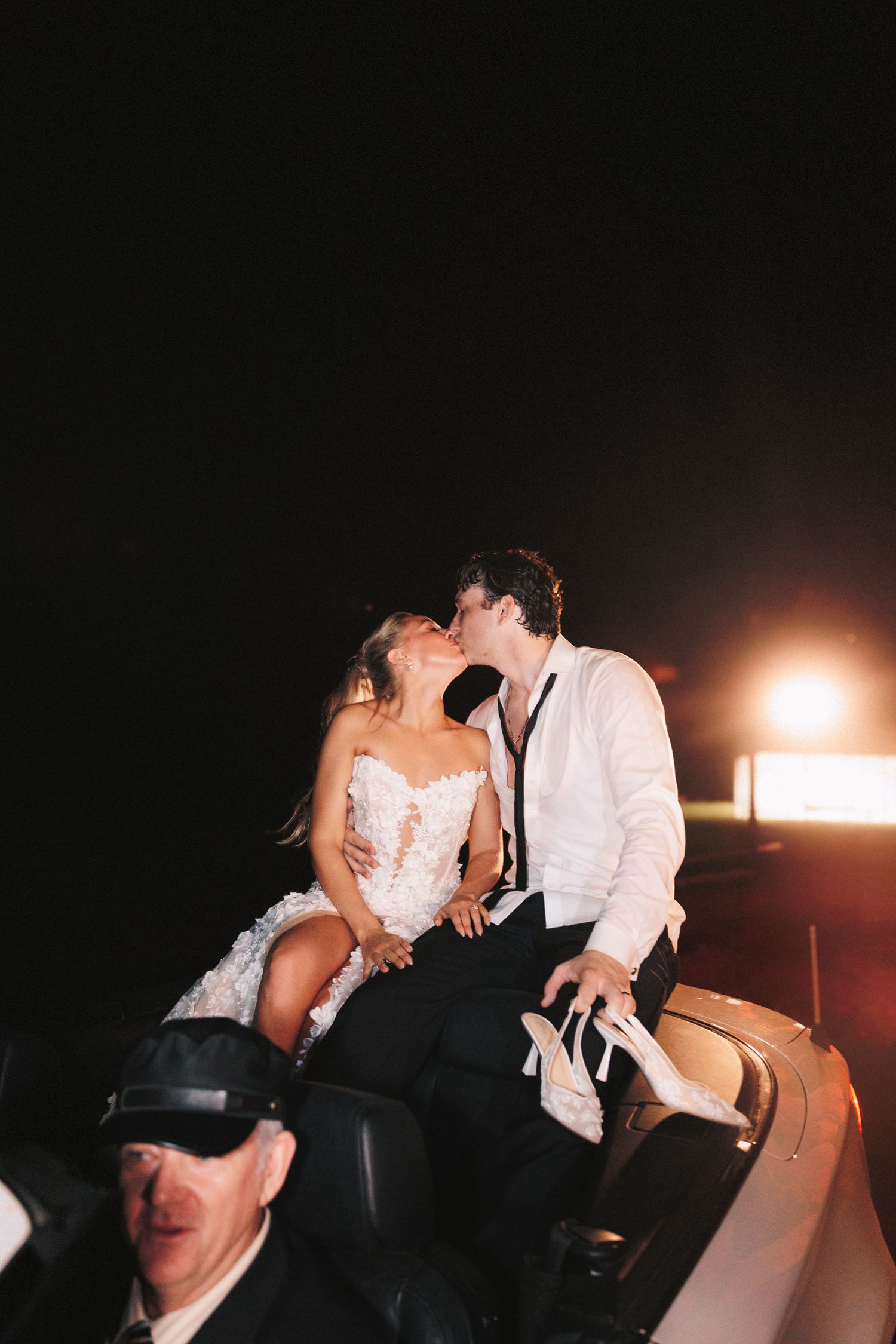 Wedding celebration captured in dramatic low-light photography during evening festivities.