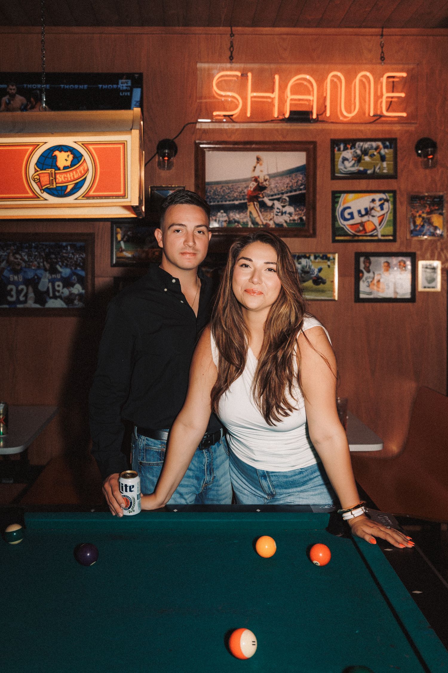 Four sequential photos of people playing pool in a dimly lit bar with neon signs and vintage decor in the background.
