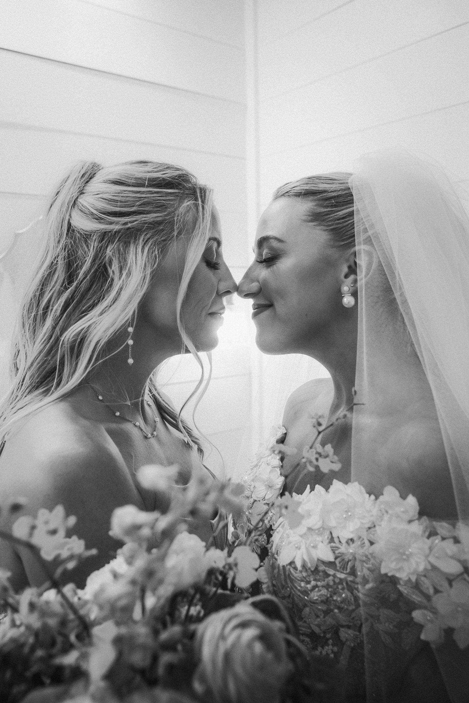 A romantic artistic black and white photo sequence featuring flowers and delicate white fabric details.