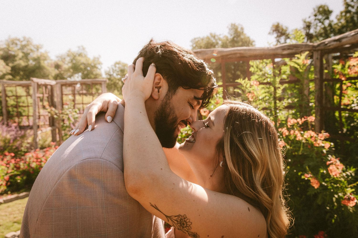 Romantic sunset photoshoot in a garden with warm golden lighting.